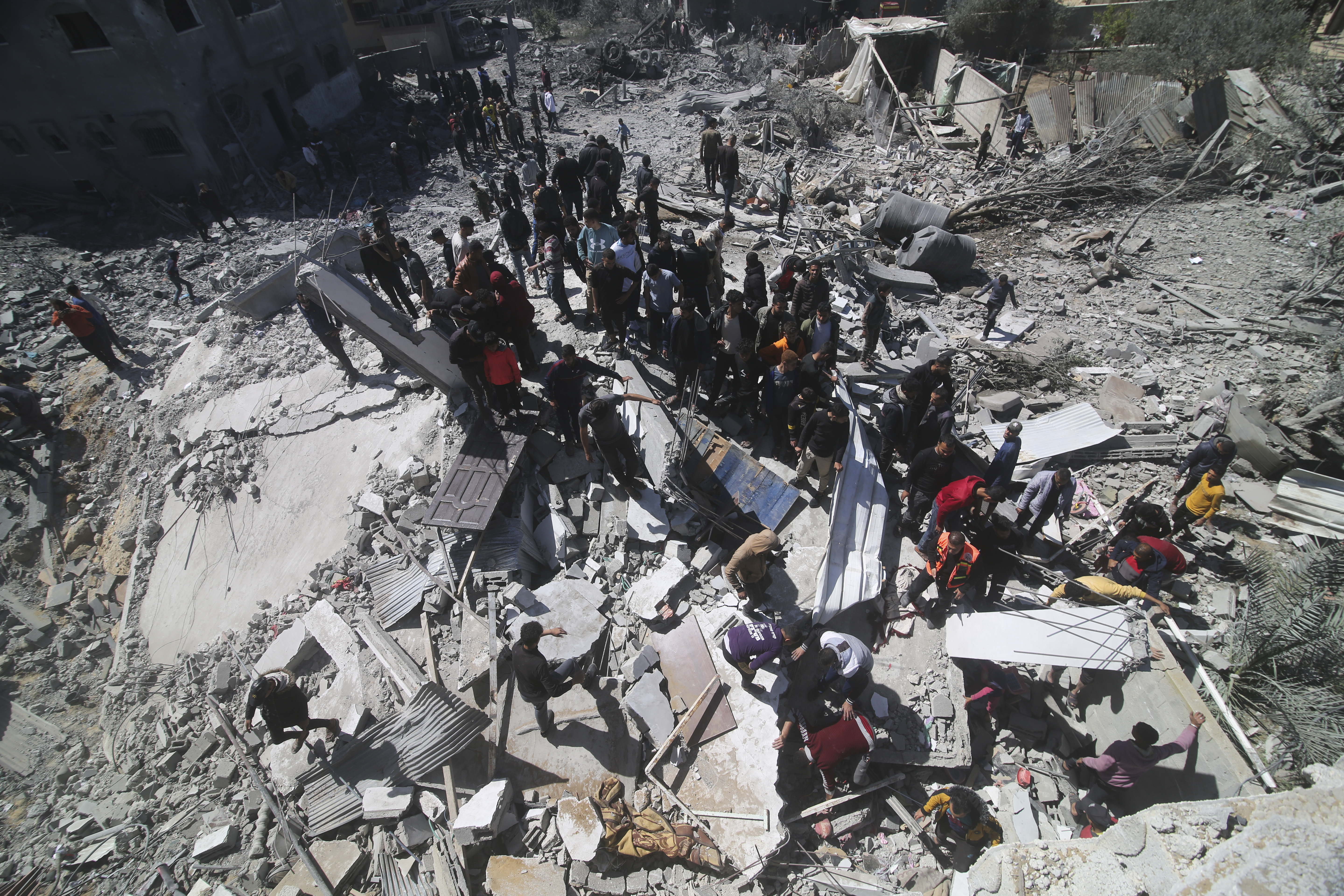 Palestinians look at a residential building destroyed in an Israeli strike in Rafah, Gaza Strip, Tuesday, March 20, 2024. Photo / AP