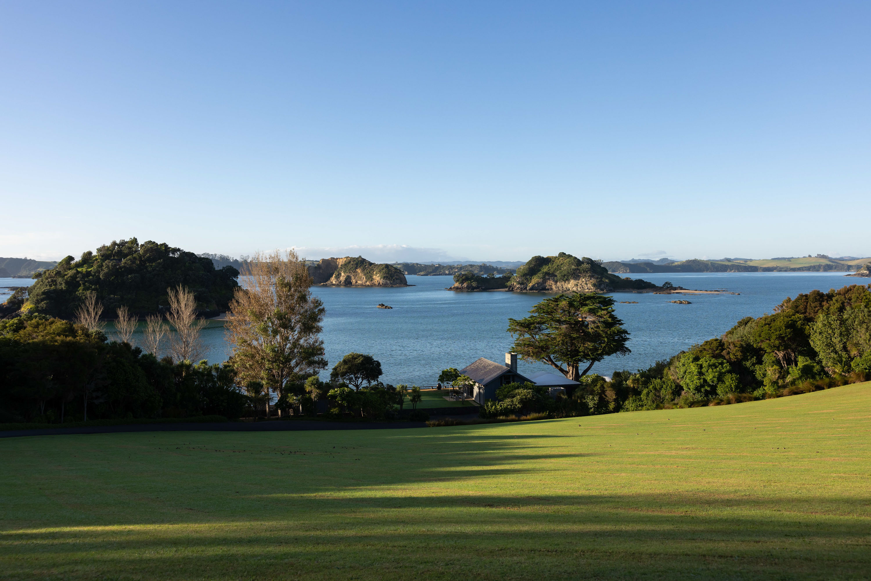 The Boathouse nestled in Wairoa Bay, and that stunning lawn.