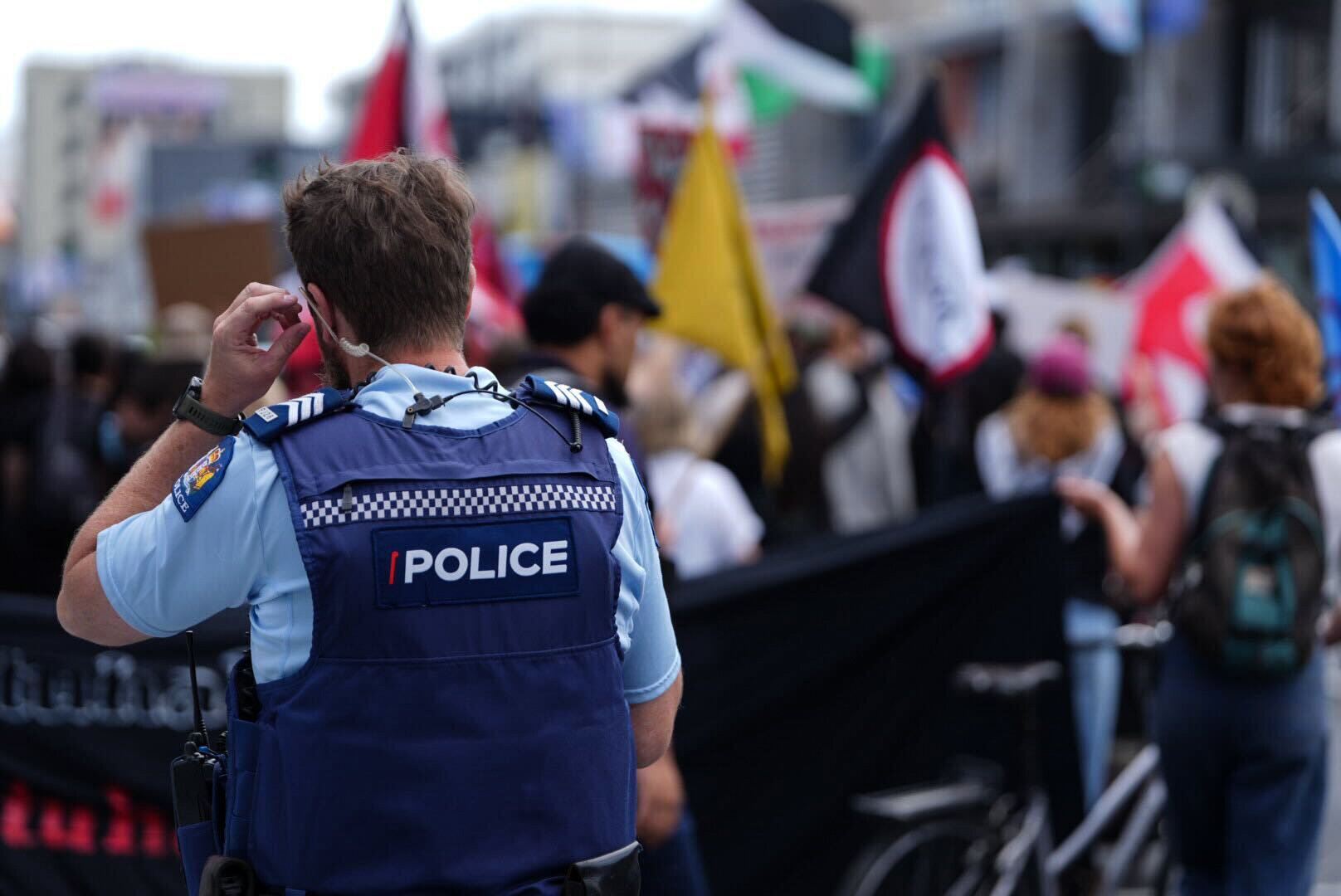 Police watch people outside the Act offices in Epsom protesting against the introduction of the Treaty Principles Bill in Parliament. Photo / Carson Bluck 