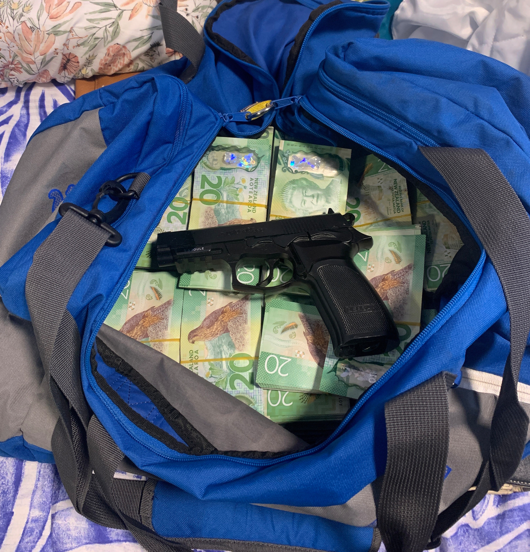 Cash and firearms were found during search warants carried out across Auckland under Operation Selena. Photo / NZ Police
