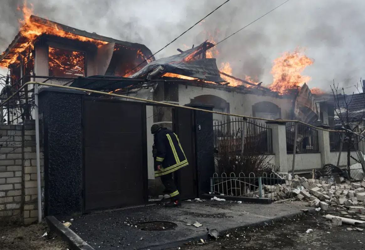 A firefighter stands at a burning house hit by the Russian shelling in Kherson, Ukraine. Photo / AP