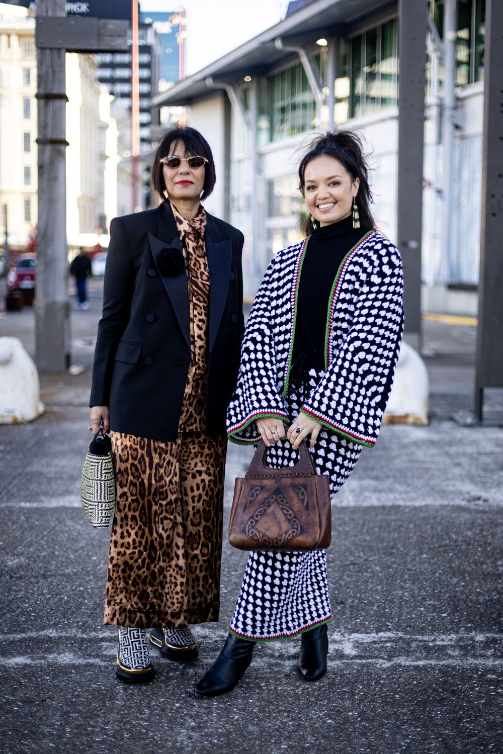 Aorangi Kora of Crochet Bae, whose knitted Tino Rangatiratanga flag poraka was included in Into The Archives, wears a 100% wool homemade crochet set. Aorangi has been constructing these sets, inspired by keffiyeh, and using them to fundraise for families in Gaza. Her aunty, Awerangi Tamihere, also wears a Crochet Bae rosette on her blazer. Photo / Dean Purcell