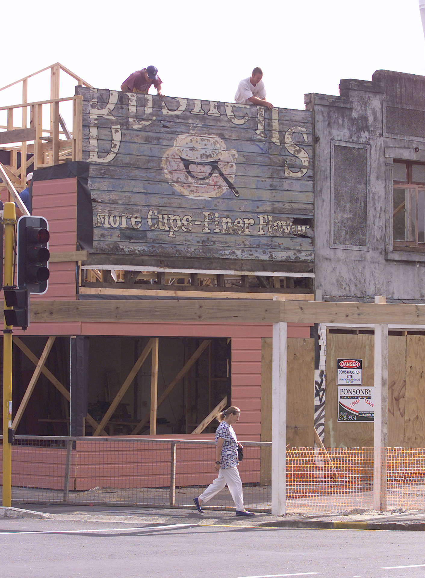 Workers dismantling the historic Bushells sign in 2001 from the Freemans Bay dairy where it had stood for more than 55 years. Photo / NZME
