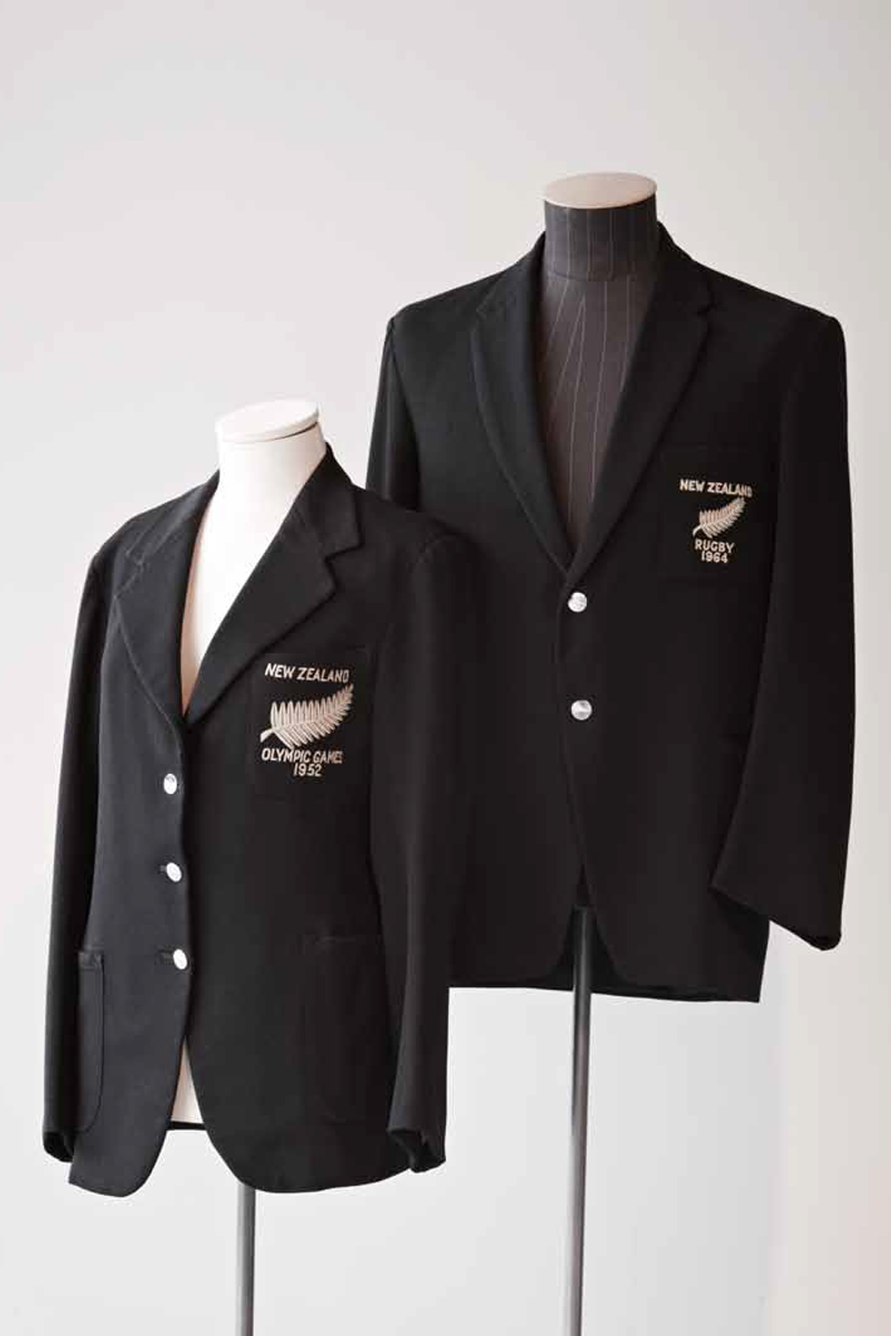 The black blazer emblazoned with a silver fern has been an almost constant feature of the New Zealand representative sporting identity. The blazer on the left was worn by Yvette Williams, winner of New Zealand's first women's Olympic gold medal. That on the right was worn by Bruce McLeod, All Black 1964-1970. Photo by Steven Tilley at the New Zealand Fashion Museum 2011 exhibition
