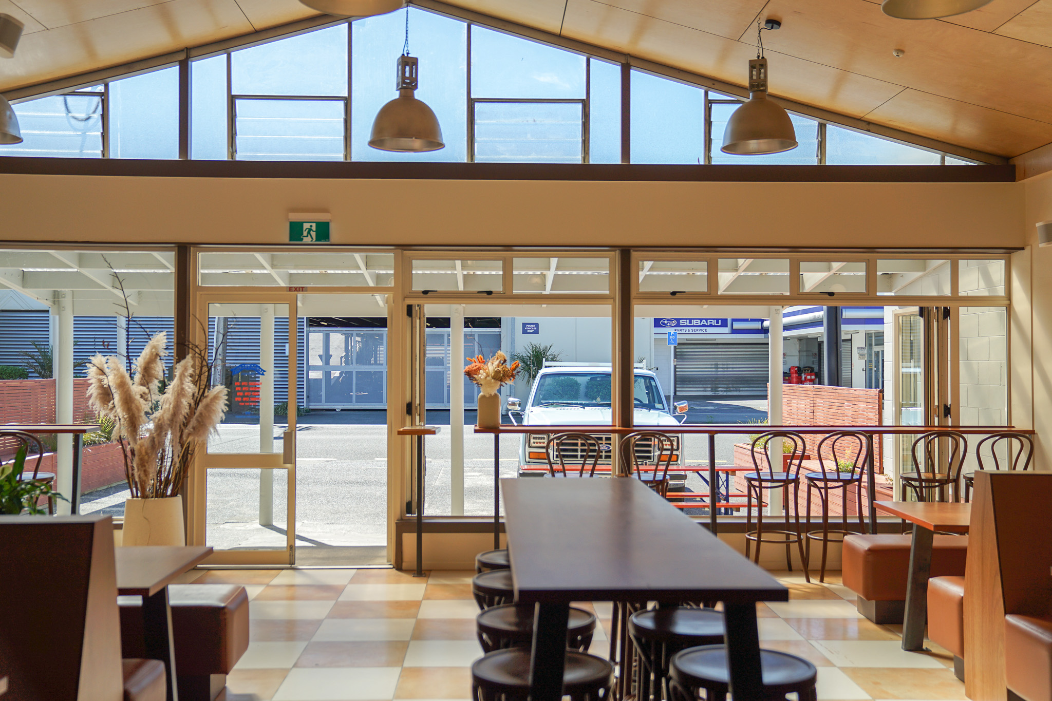 Local Talent Taverna in Whangārei charms with a chequerboard floor and wooden booths.
