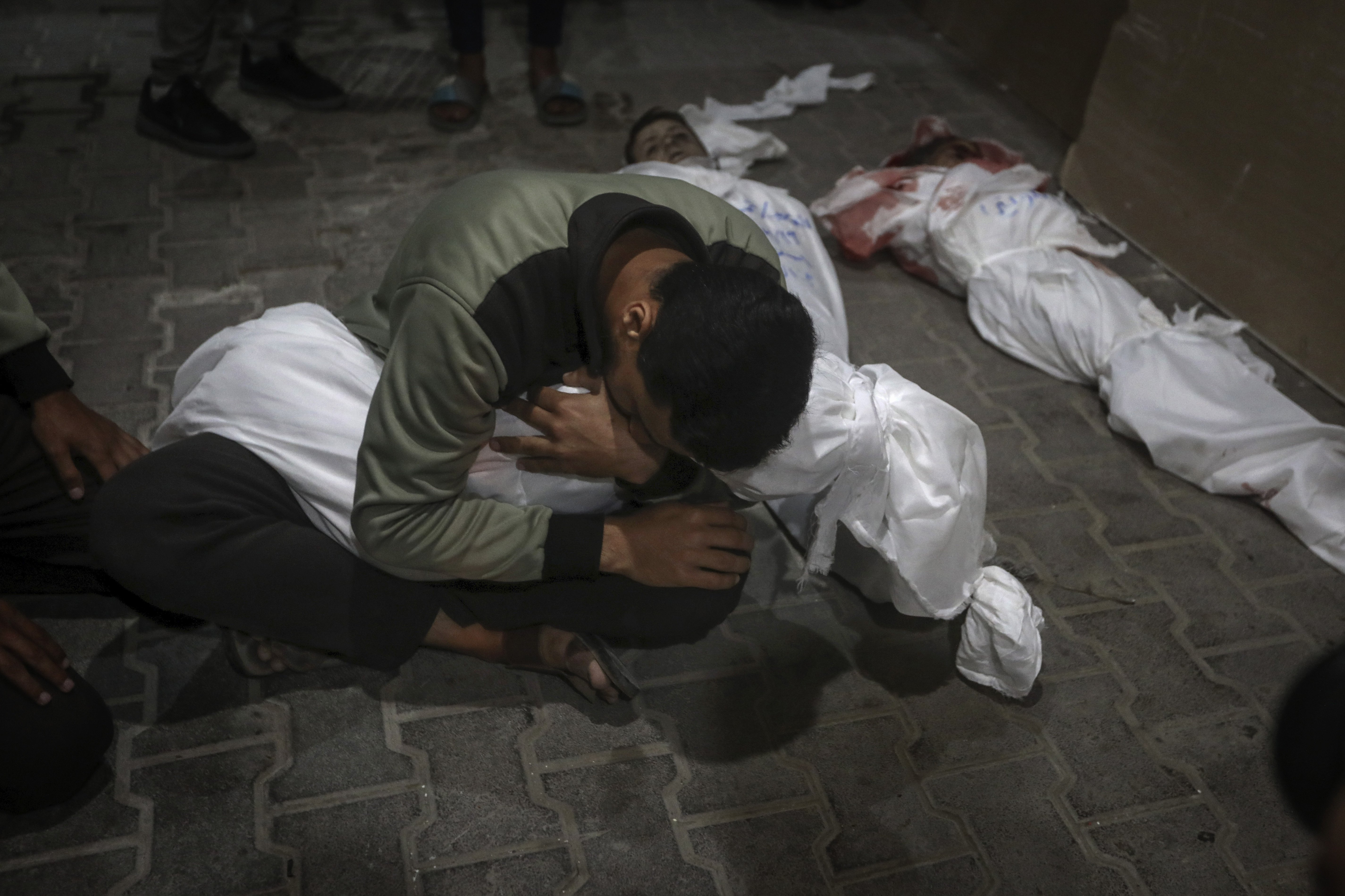 A Palestinian youth mourns his relative killed in the Israeli bombardment of the Gaza Strip, at the morgue of the Kuwaiti Hospital in Rafah refugee camp, southern Gaza Strip. Photo / AP