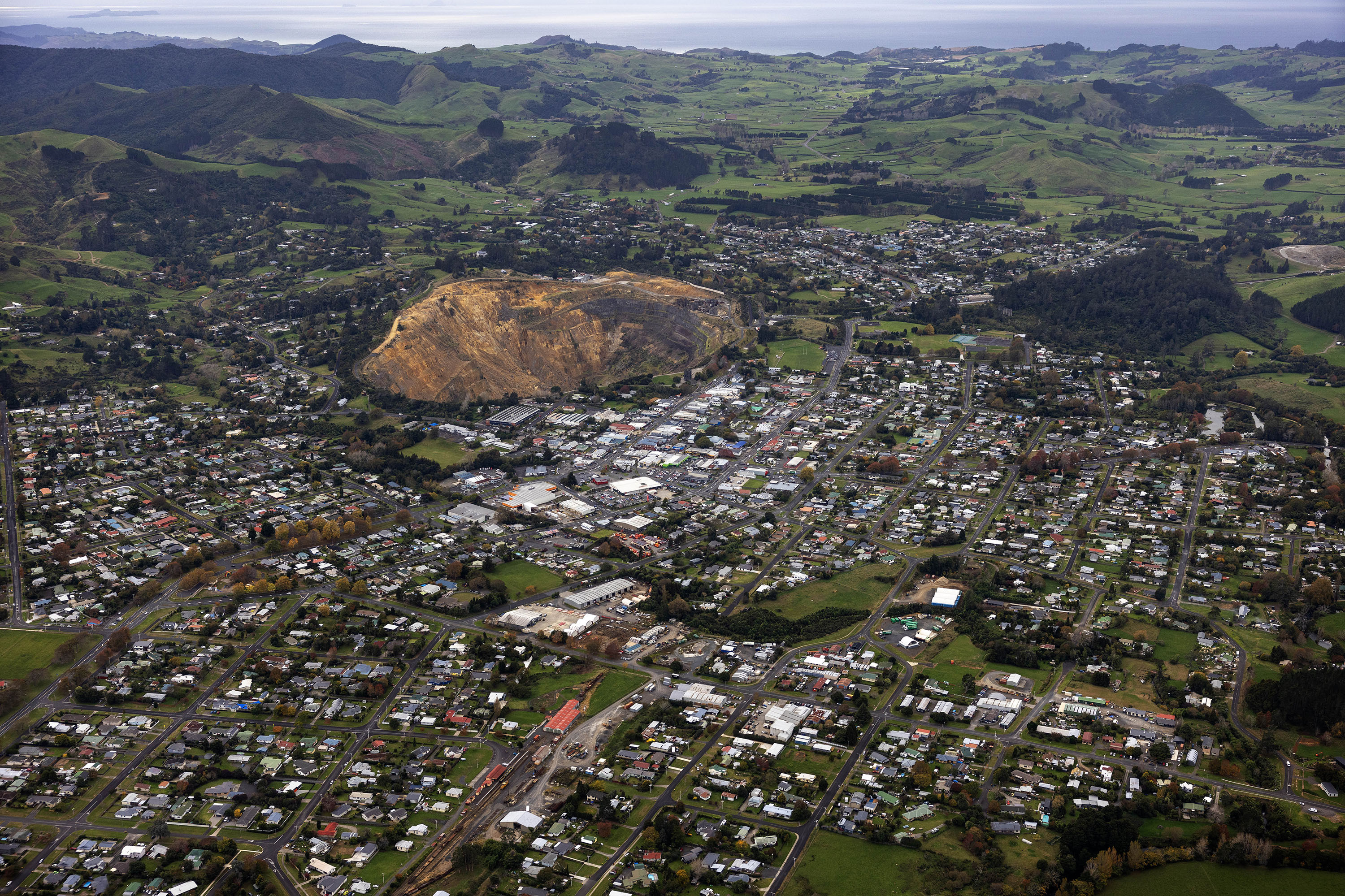 The Martha mining pit and the township of Waihī, with Wharekirauponga Forest in the background. Photo / Mike Scott