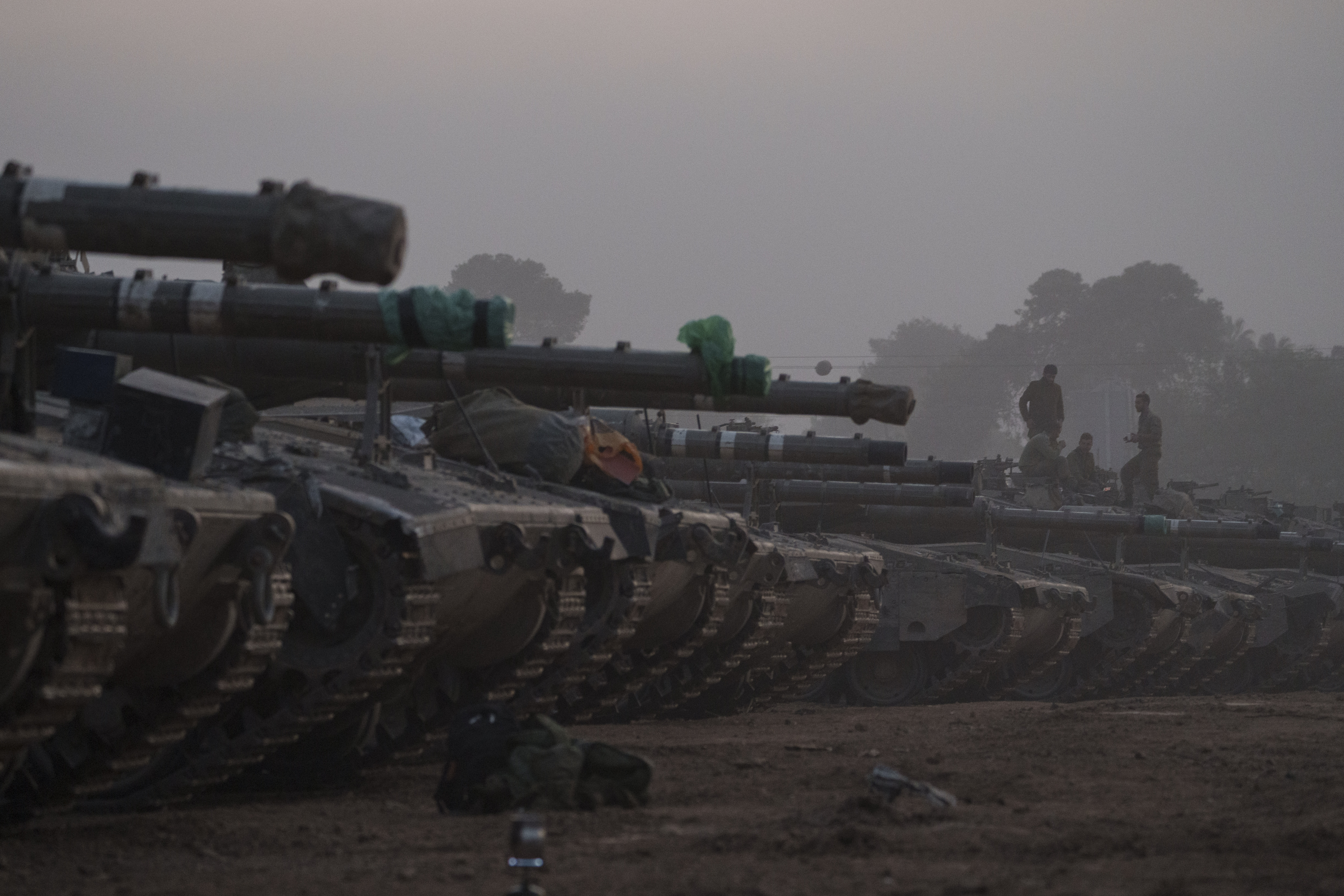 Israeli soldiers stand on top of a tank in a staging area at the Israeli-Gaza border in southern Israel. Photo / AP