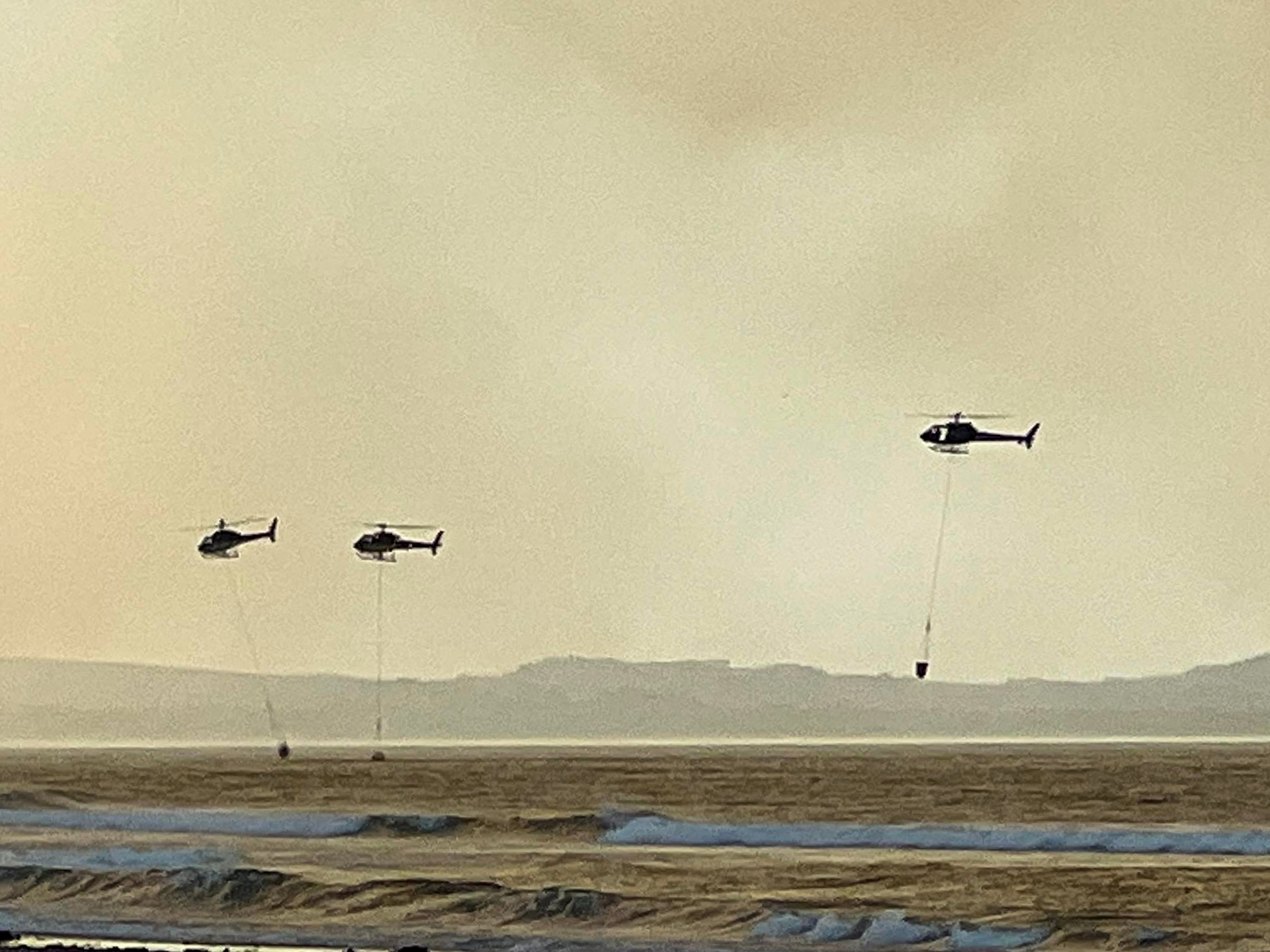 The number of helicopters fighting the blaze has been boosted from three to six since 2pm with two more on standby. Photo / Lisa Everitt