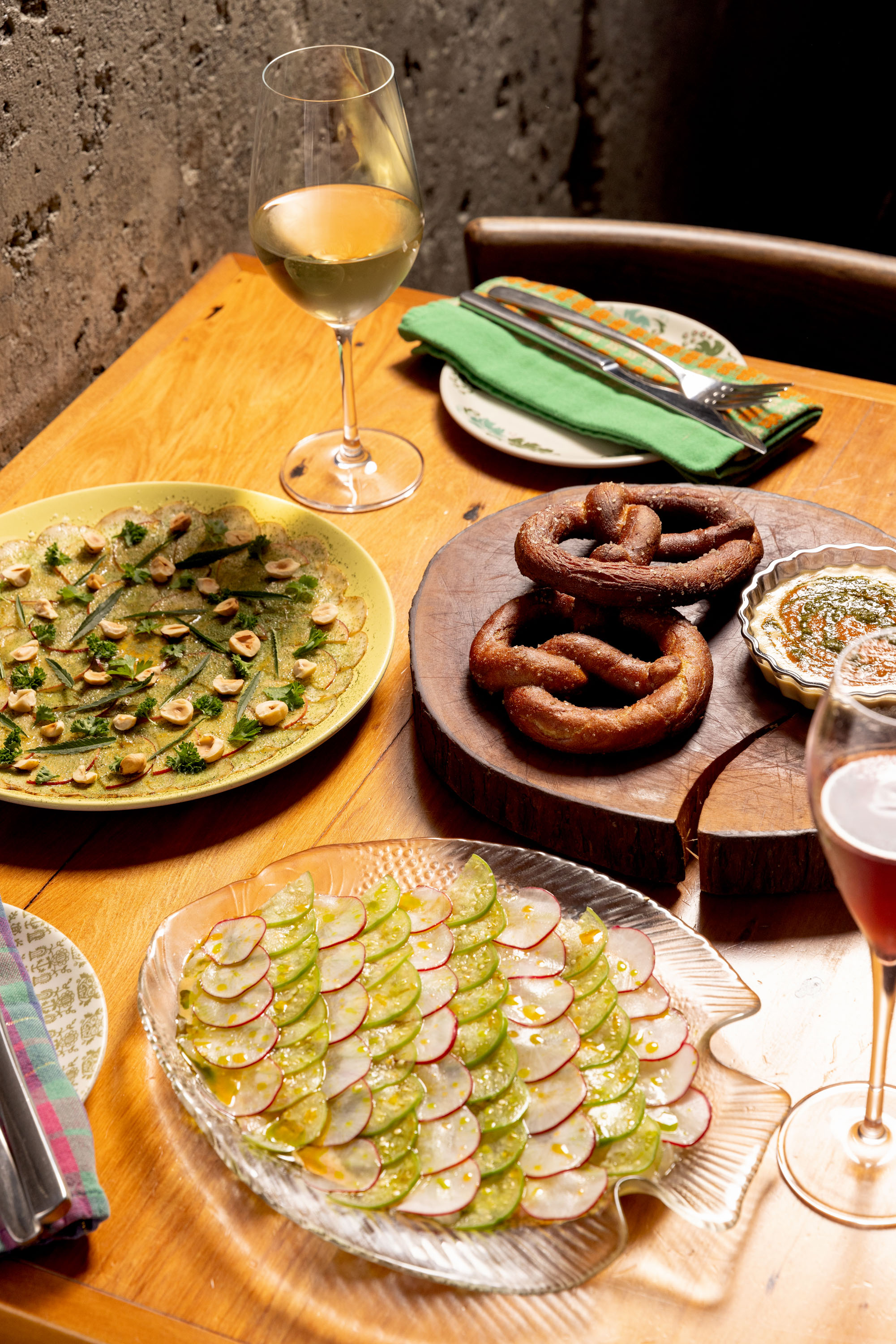The blackboard menu at Graze changes often. Pictured is the Jerusalem artichoke with apple and hazelnuts; butterfish crudo with radish and tomatillo; and the soft pretzel with pizza dip. Photo / Babiche Martens