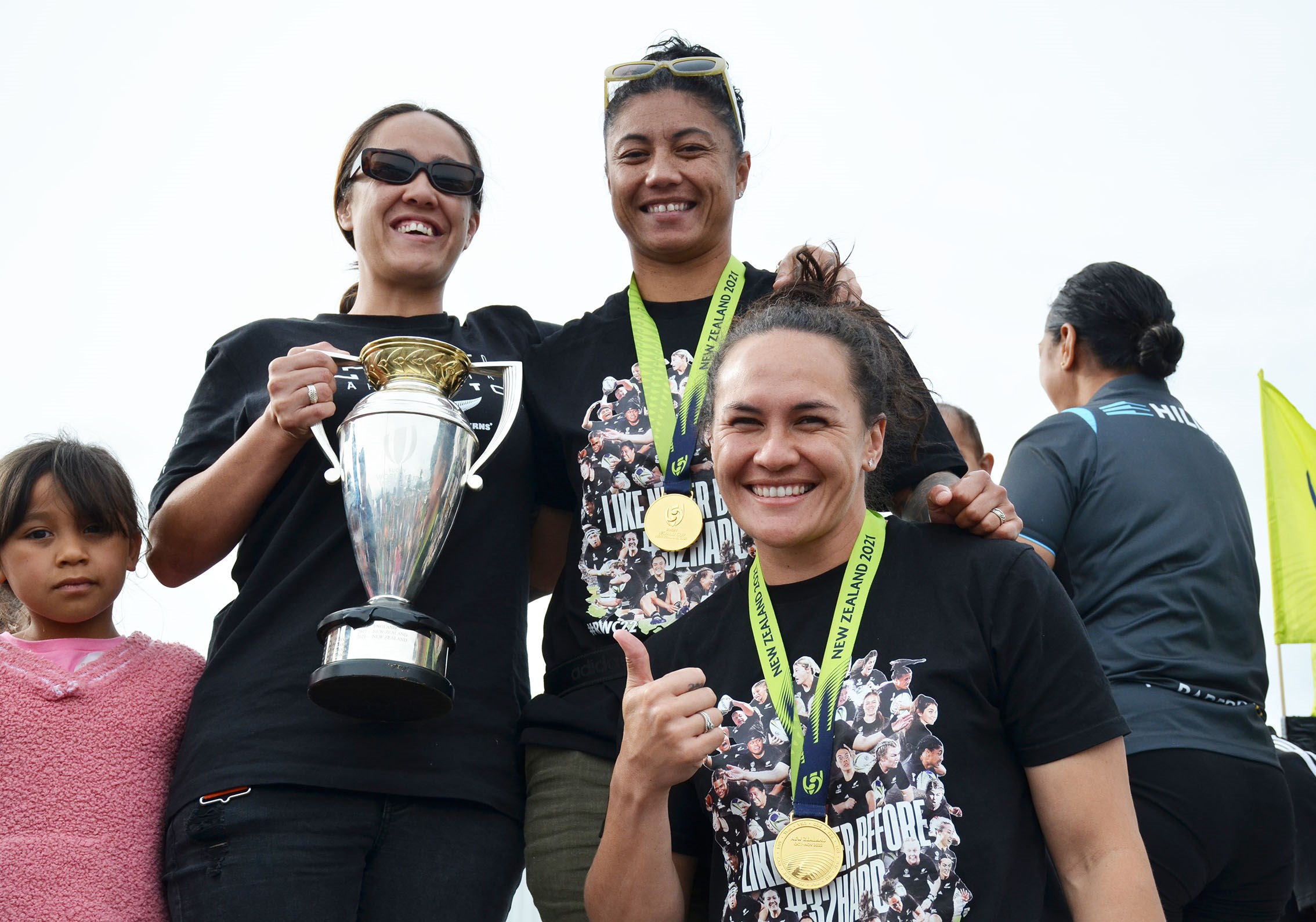 World champion Black Ferns Renee Wickliffe (top right), Portia Woodman and Arihiana Marino-Tauhinu celebrate their team's title. Photo / Debbie Beadle
