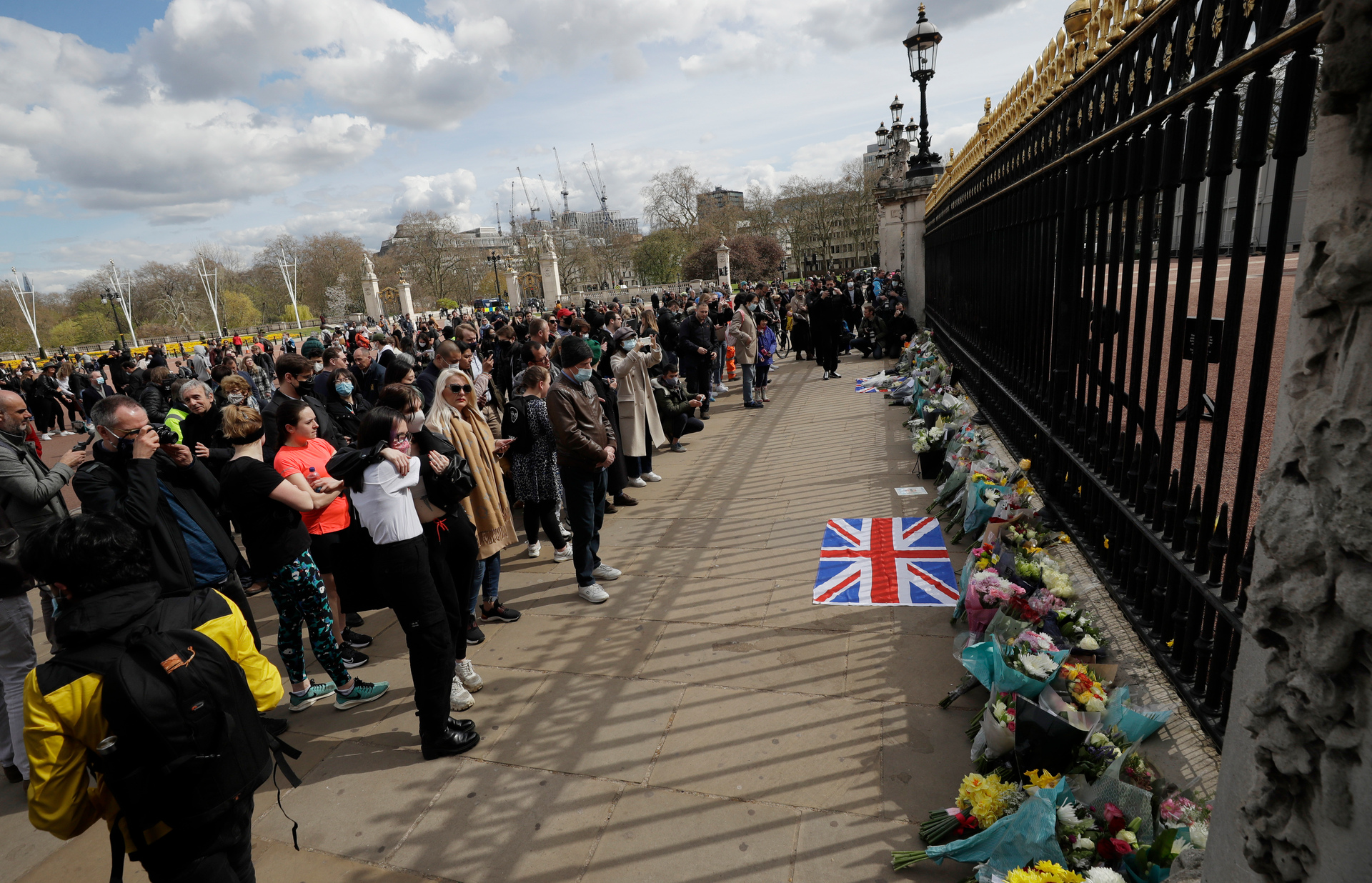People view flowers left in front of the gate at Buckingham Palace in London, after the announcement of the death of Britain's Prince Philip. Photo / AP