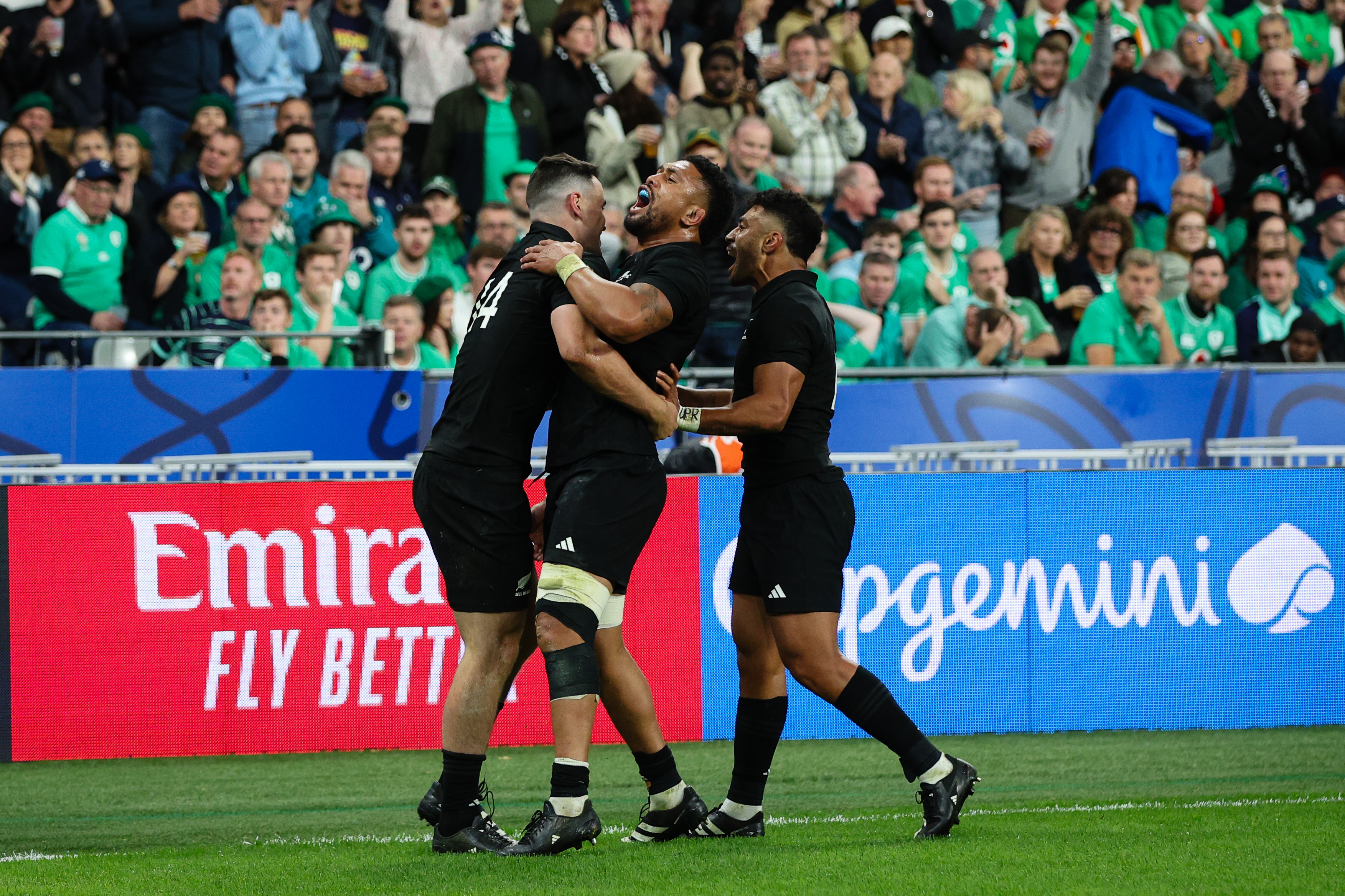 Will Jordan, Ardie Savea and Richie Mo'unga celebrate the All Blacks' third try. Photo / Getty Images
