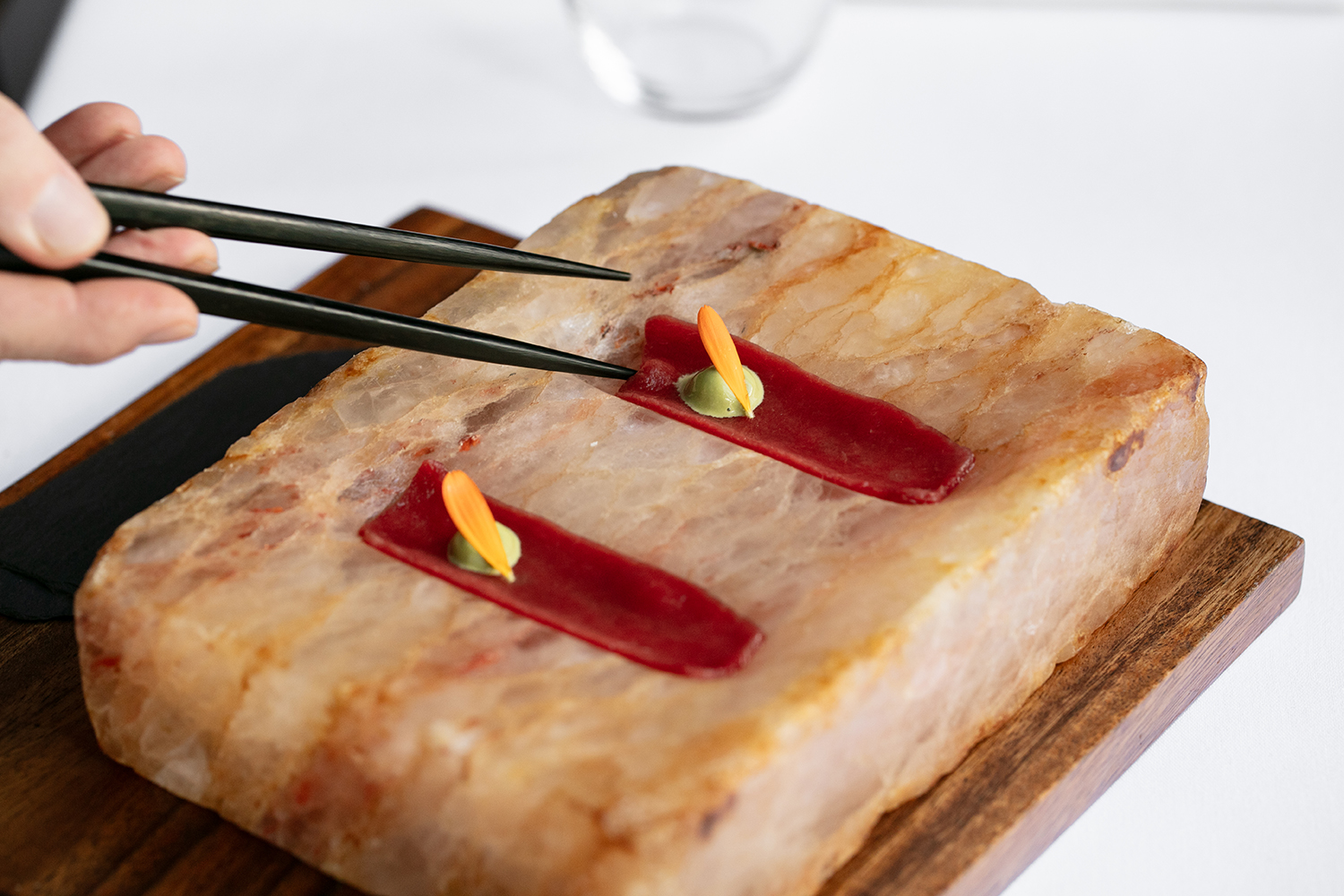 Slivers of venison served on a pink salt block. Photo / Babiche Martens
