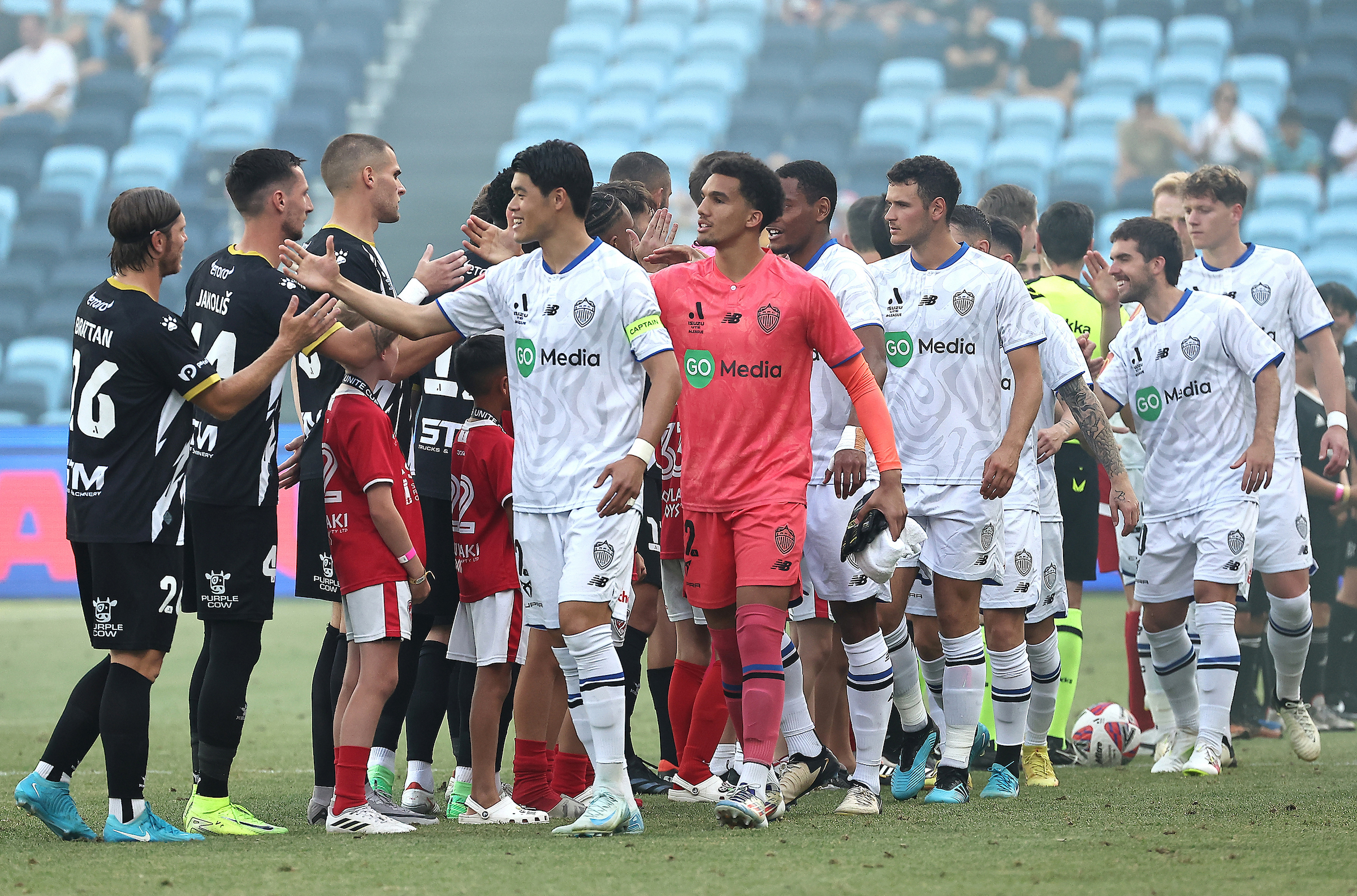 Teams exchange pleasantries before the match between Macarthur FC and Auckland FC. Photo / Photosport