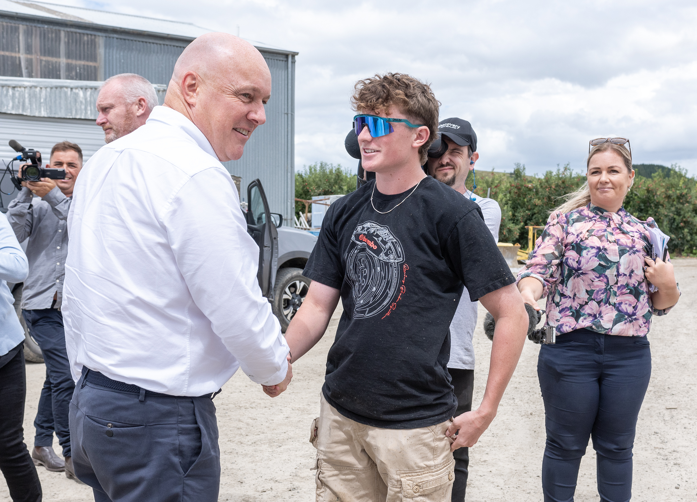 Prime Minister Christopher Luxon shaking hands with Daniel Pietersma, 20,  who experienced Cyclone Gabrielle's flooding first-hand on their Puketapu farm with his family.  Photo / Connull Lang
