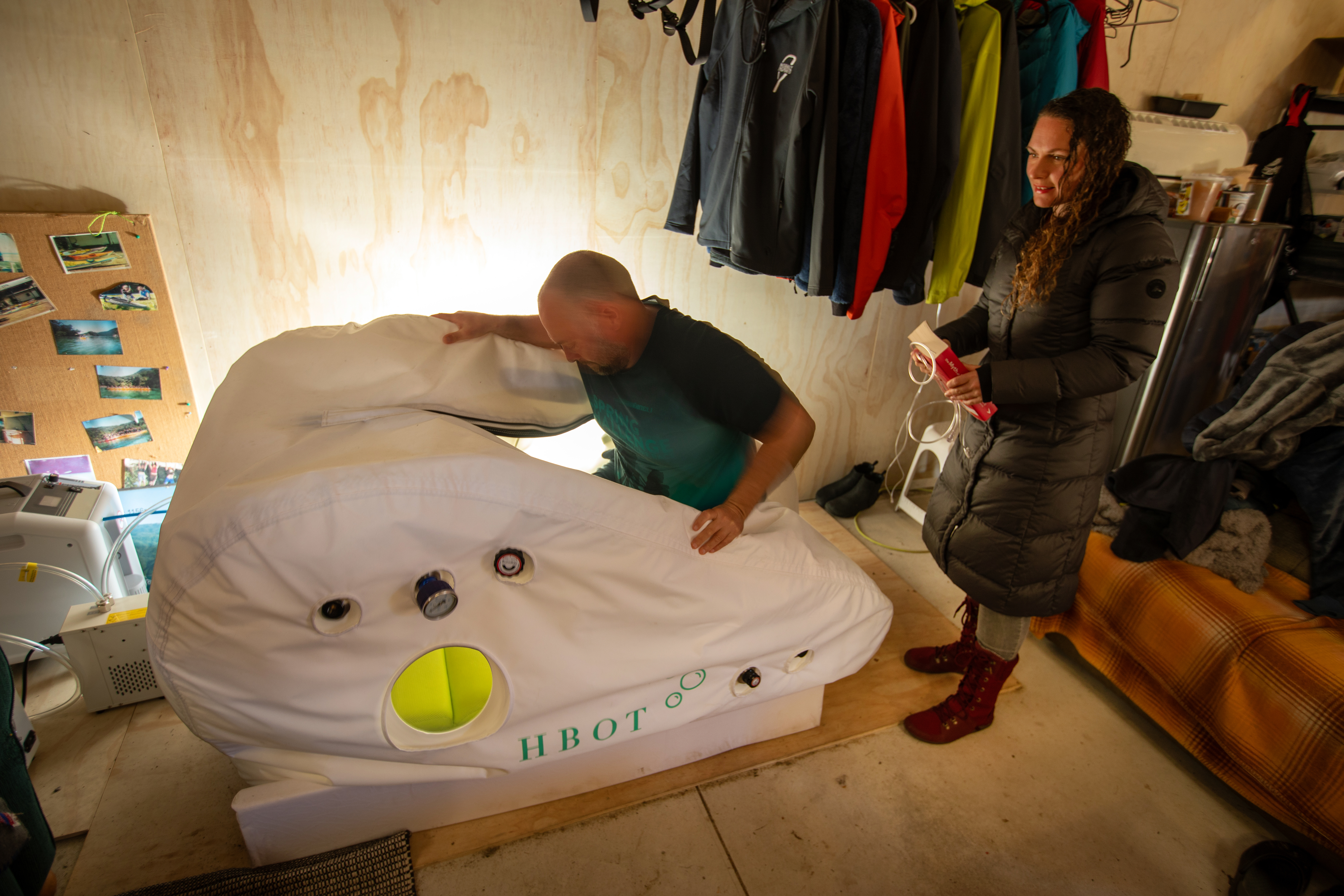 Former NZSAS member Gregg Johnson with partner Nicole Walker getting into the hyperbaric chamber he uses to encourage brain health. Photo / Tim Cuff