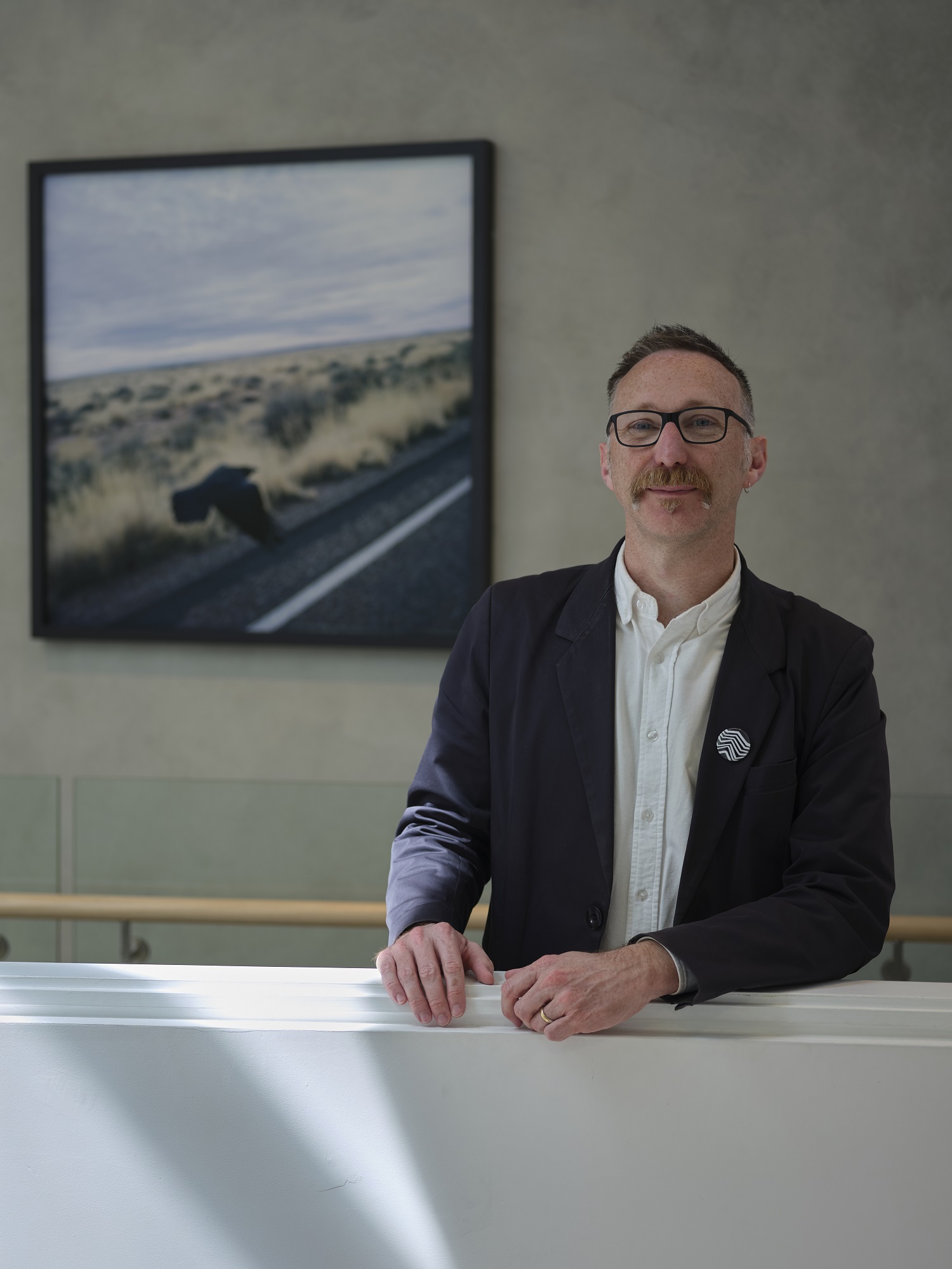 Andrew Clifford in front of a work by artist Joyce Campbell. Photo / Sam Hartnett