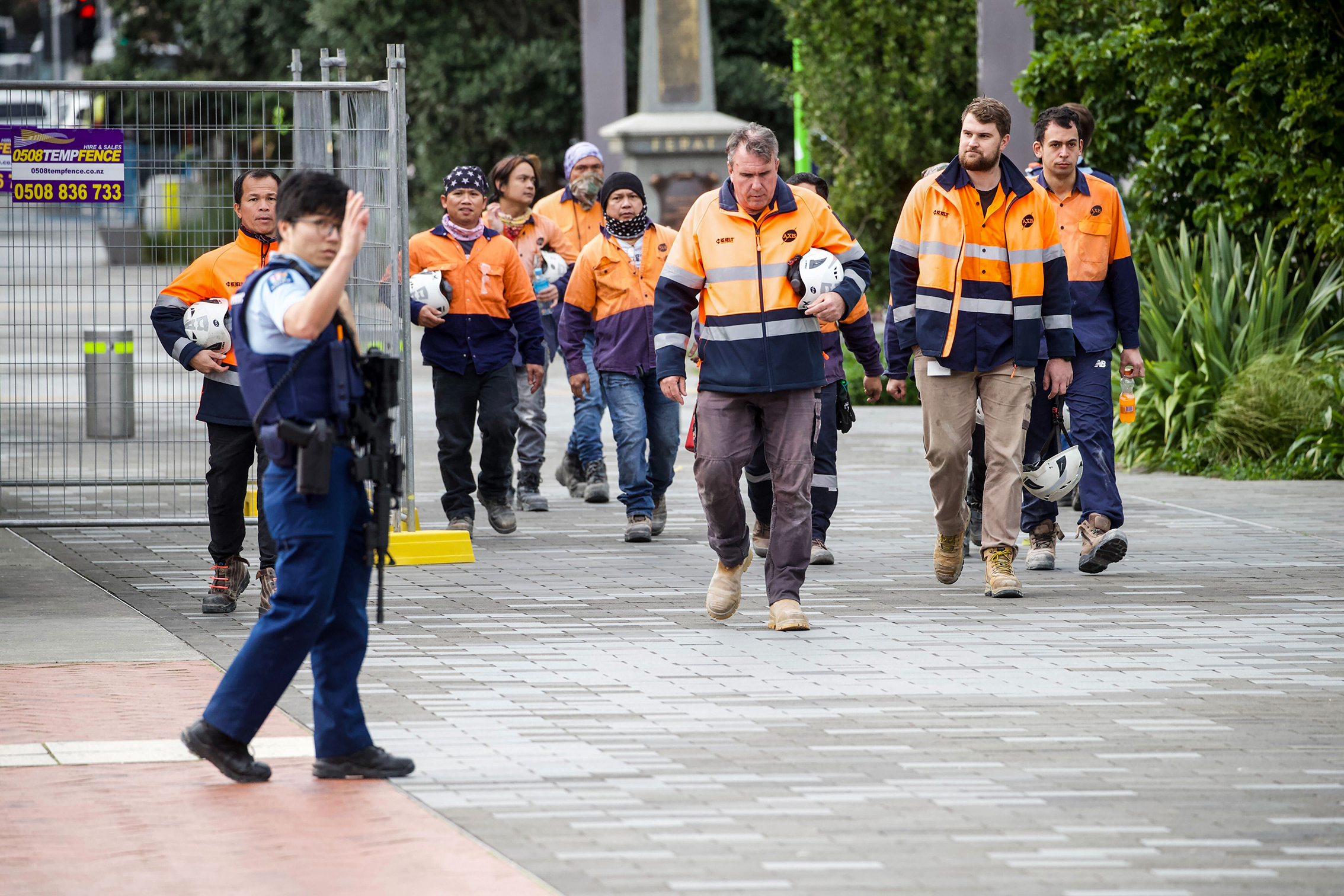 Armed police and construction workers in Downtown Auckland. Photo / Jason Oxenham