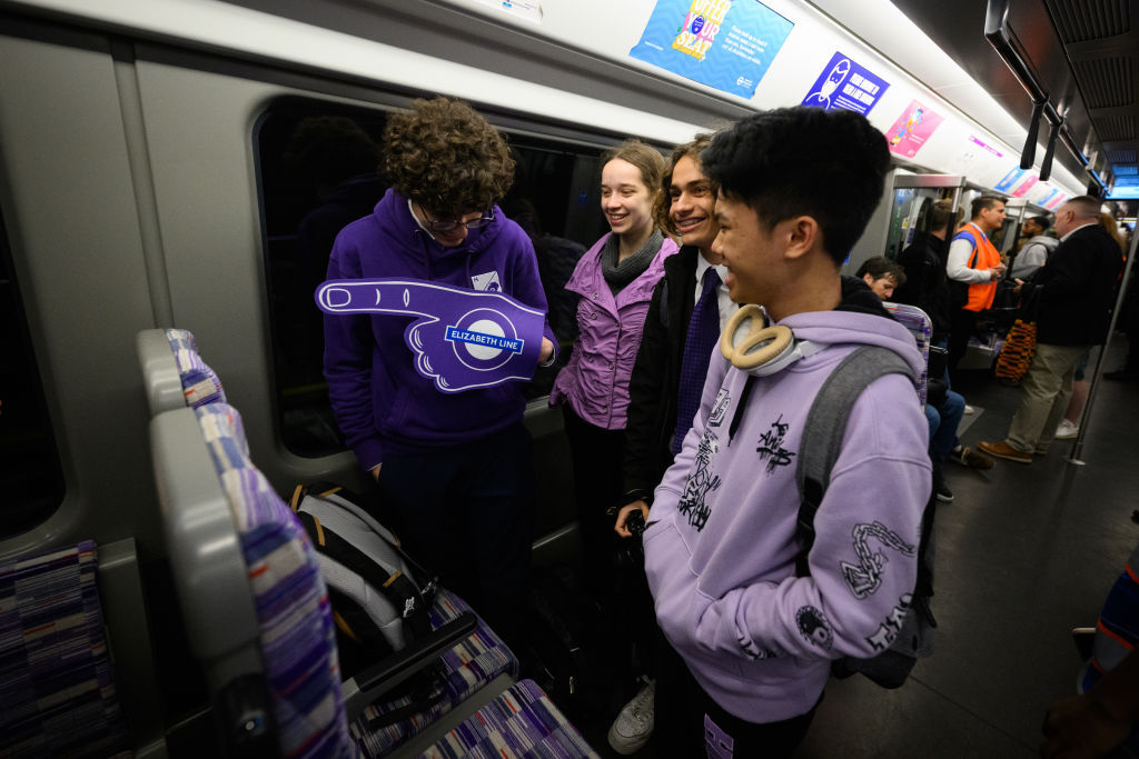 Rail enthusiasts travel on the first eastbound train on London's new Elizabeth Line. Photo / Getty Images