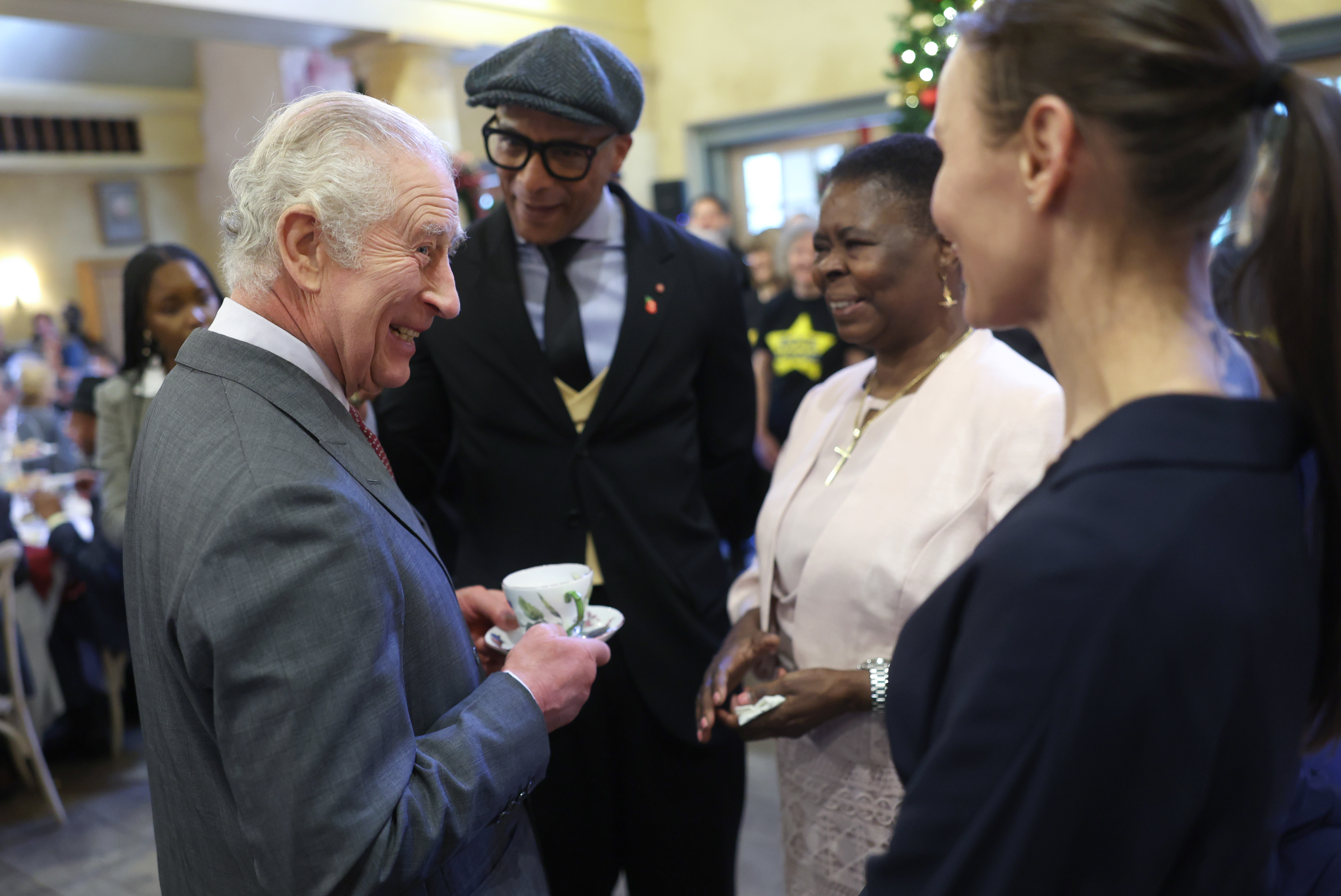 King Charles III's shares a joke with TV presenter Jay Blades (second left) and guests as he attends his 75th birthday party hosted by the Prince's Foundation at Highgrove House on November 13, 2023 in Tetbury, England. Photo / Getty Images