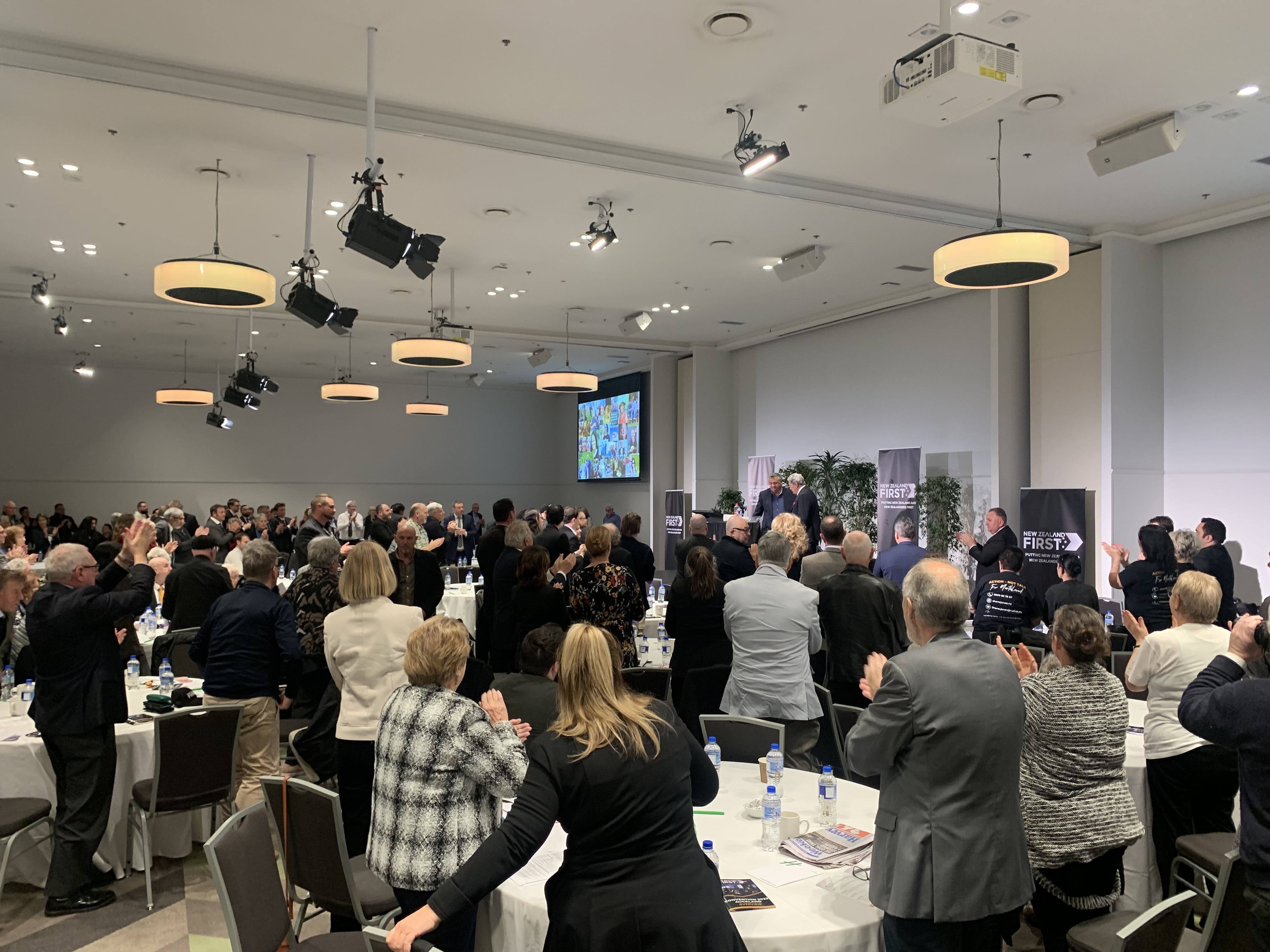 NZ First members give a standing ovation to Patient Voice Aotearoa's Malcolm Mulholland. Photo / Adam Pearse
