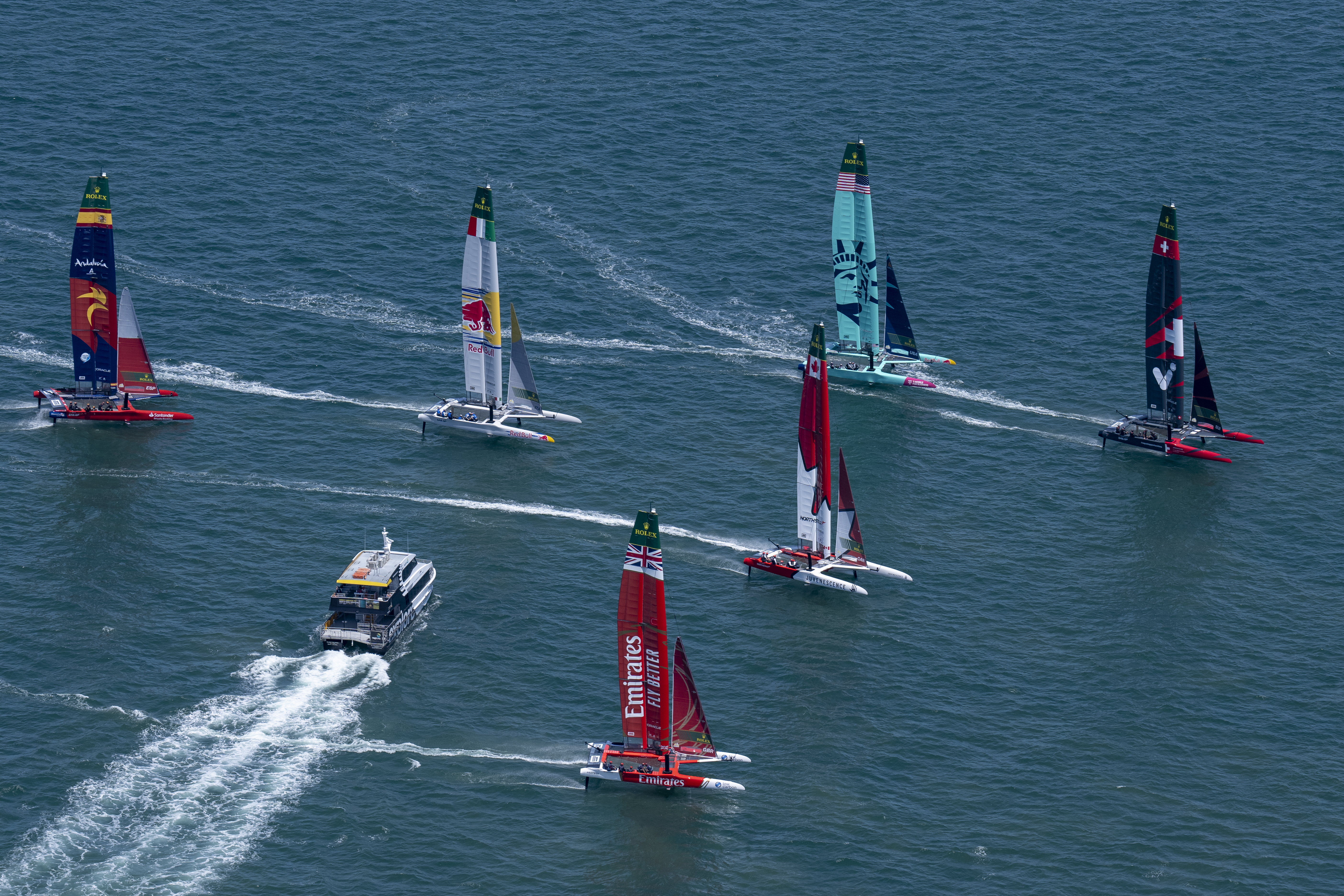 A passenger ferry cuts across the fleet during a practice session ahead of SailGP's debut event in Auckland. Photo / Bob Martin, SailGP