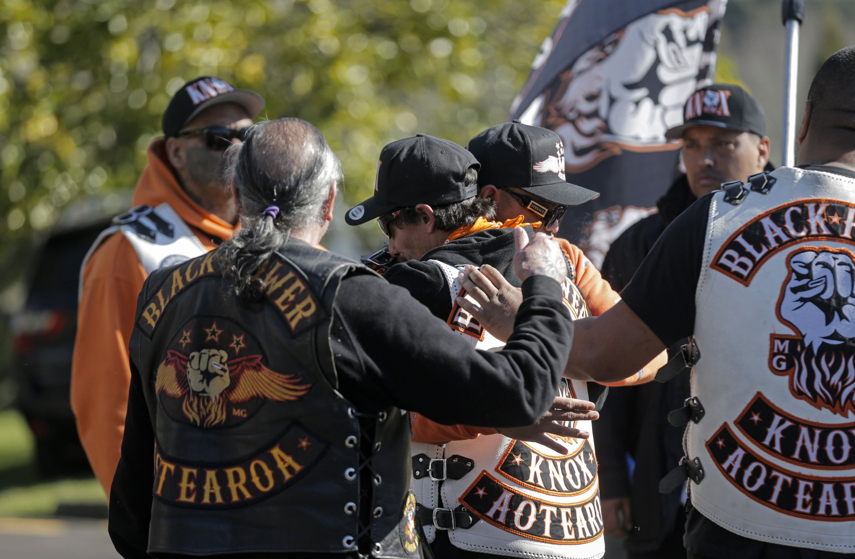 The grieving husband of Jo Sione-Lauaki, Jared Sione-Lauaki, (centre) being hugged by mourners. Photo / Alex Burton 
