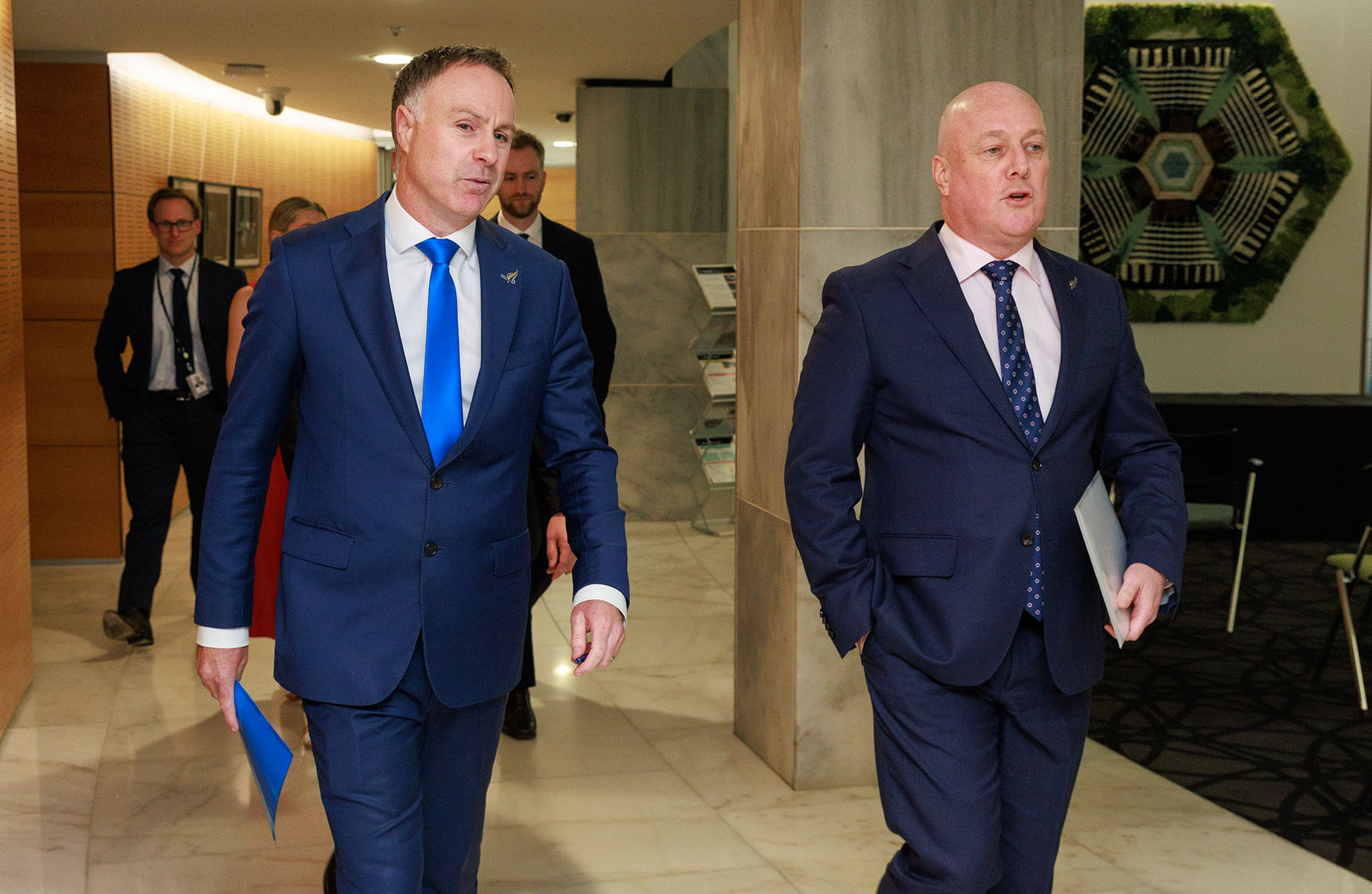 Prime Minister Christopher Luxon (right) and Local Government Minister Simon Watts walk into their press conference. Photo / Mark Mitchell 