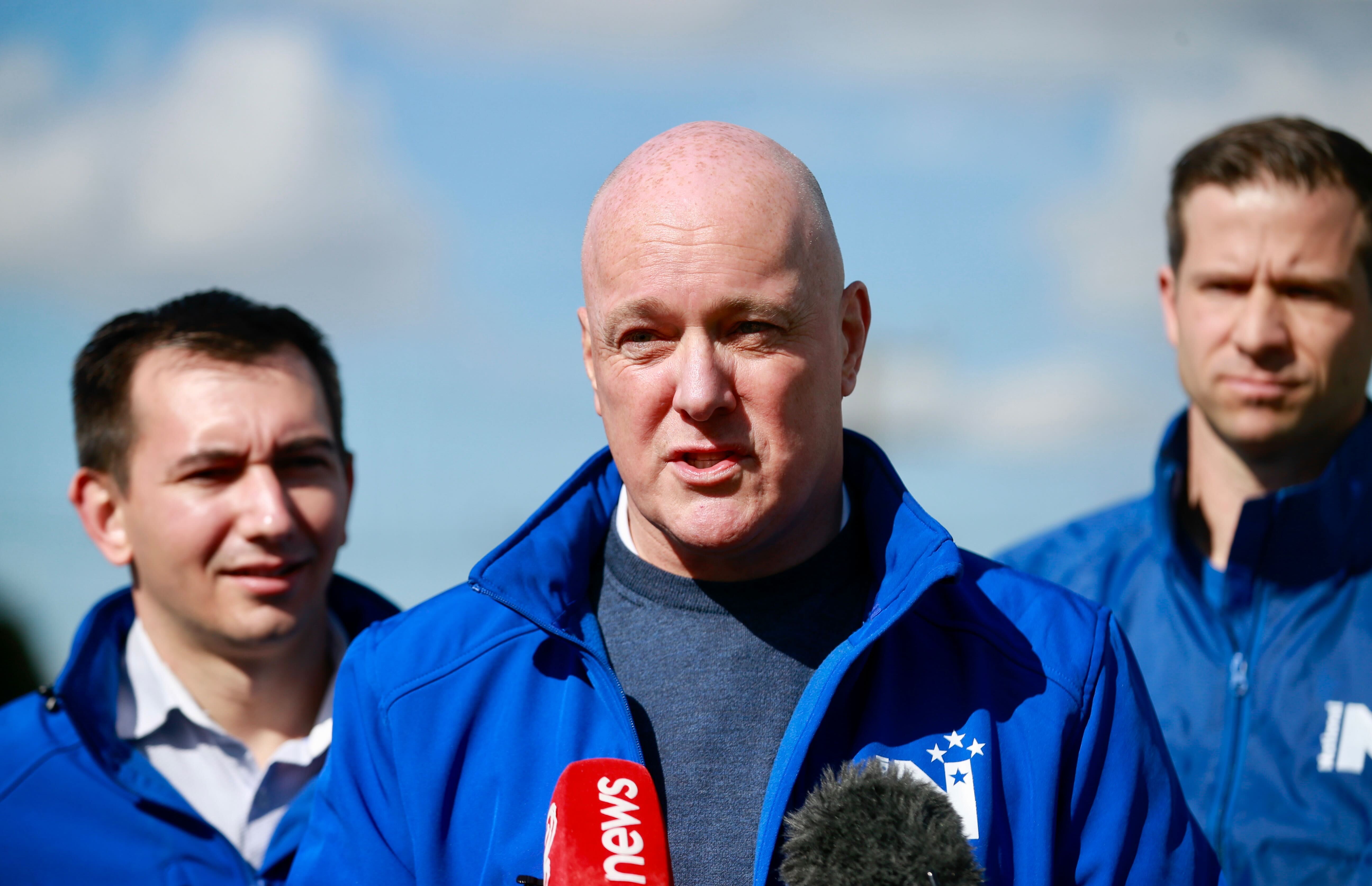 National leader Christopher Luxon (centre) with MPs Simeon Brown (left) and Chris Penk, speaks to the Govt's Auckland harbour crossing decision. Photo / Alex Burton
