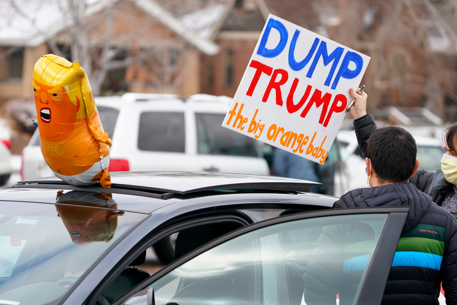 Participants prepare their vehicle calling for the impeachment of President Donald Trump in Denver. Photo / AP