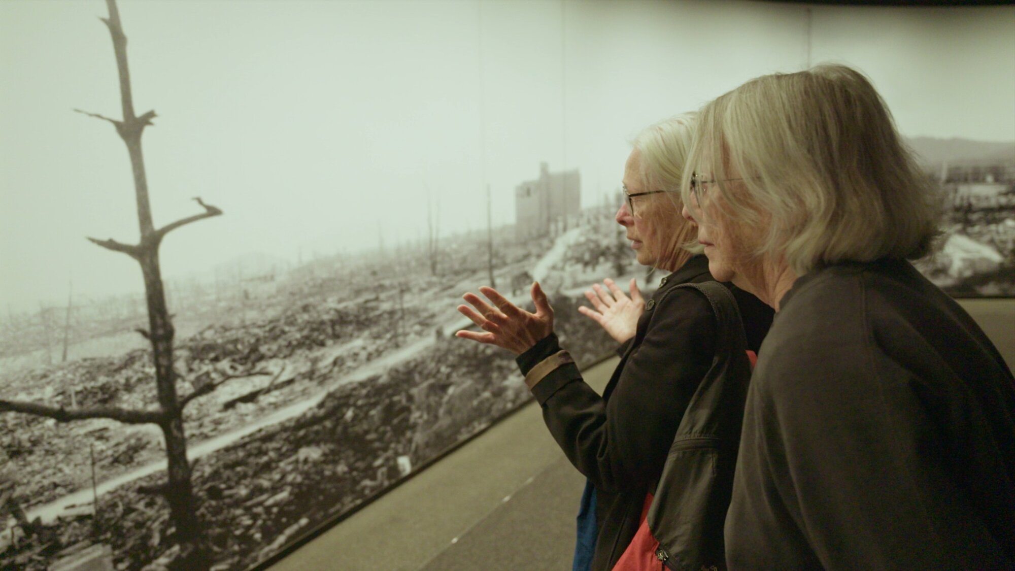 Film-maker Dame Gaylene Preston, left, and artist Dame Robin White see Hone Tūwhare's poem 'No Ordinary Sun' reflected in images of the atomic bomb's destructive blast, during a visit to the Hiroshima Peace Memorial Museum in Japan.