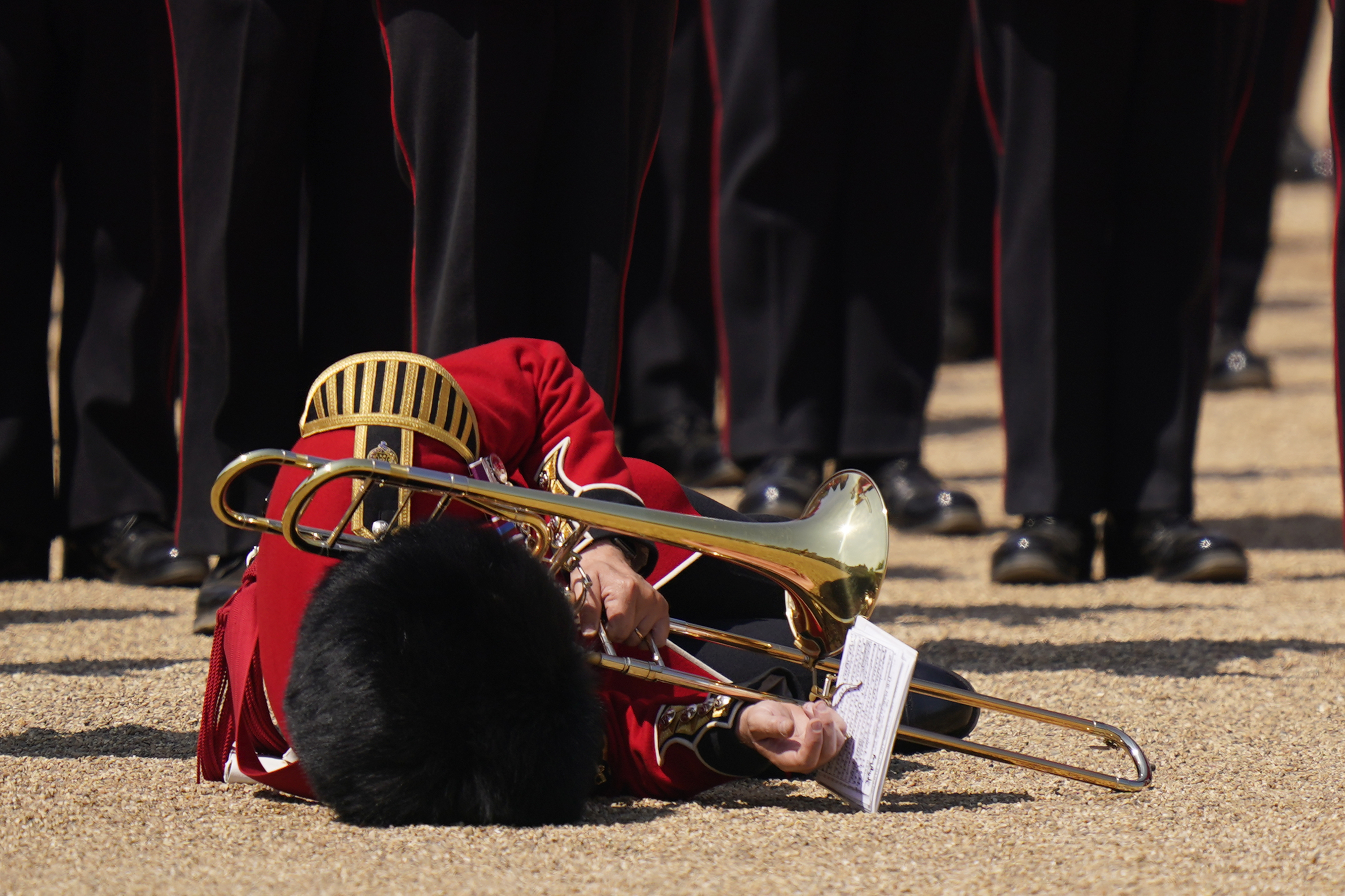 A trombone player of the military band faints during the Colonel's Review, the final rehearsal of the Trooping the Colour on Saturday. Photo / AP