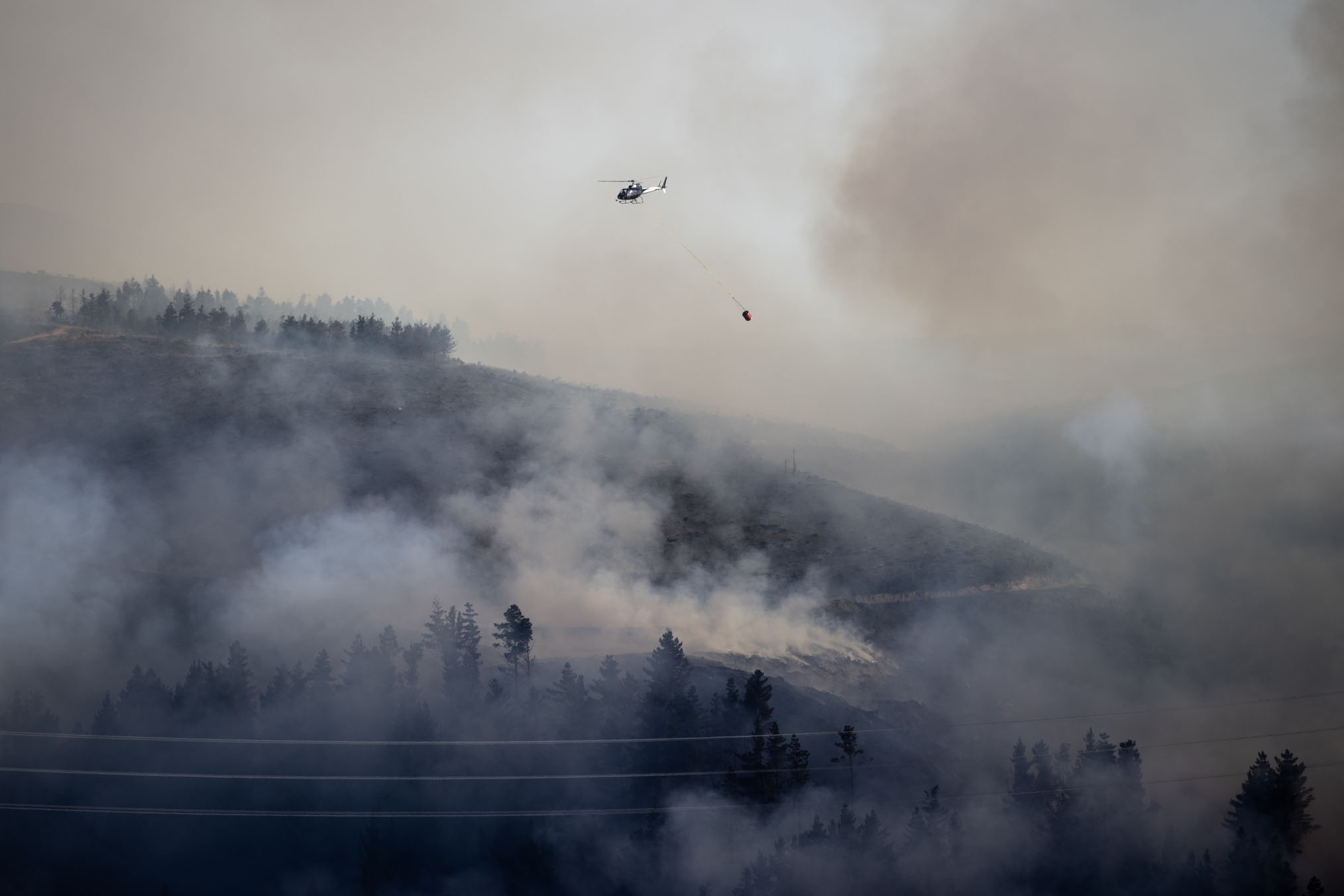 Sirens and helicopters could be heard across the Port Hills as emergency services blocked people from passing cordons. Photo / George Heard