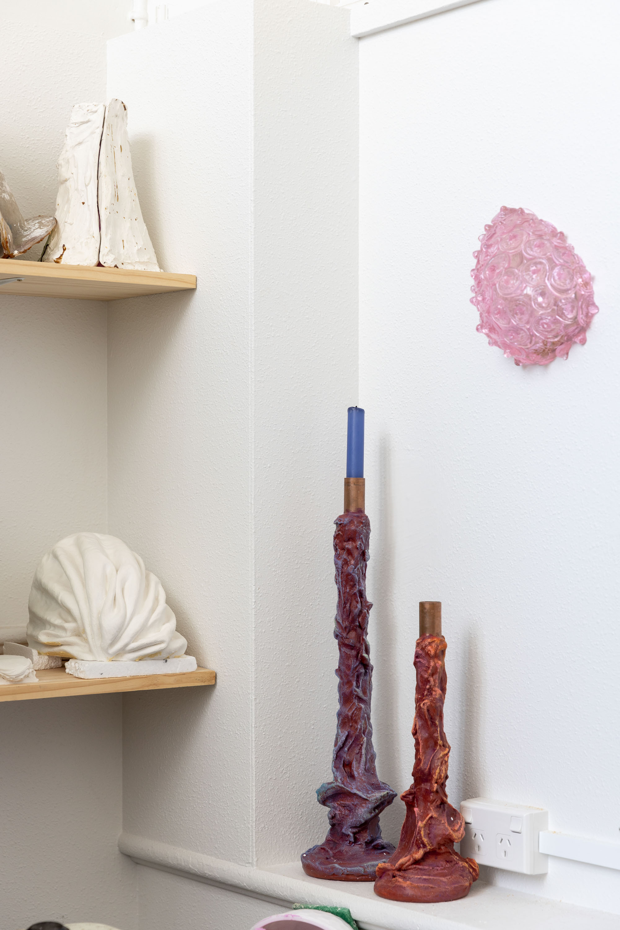 Katherine Rutecki’s Ponsonby studio shelves are filled with research and development, as well as Ghastly ghoststicks candelabra. On the wall is Pink Bubble, from the Motherform series, made from blown and hot cast Erbium glass, 200x220x120mm, 2016. Photo / Babiche Martens