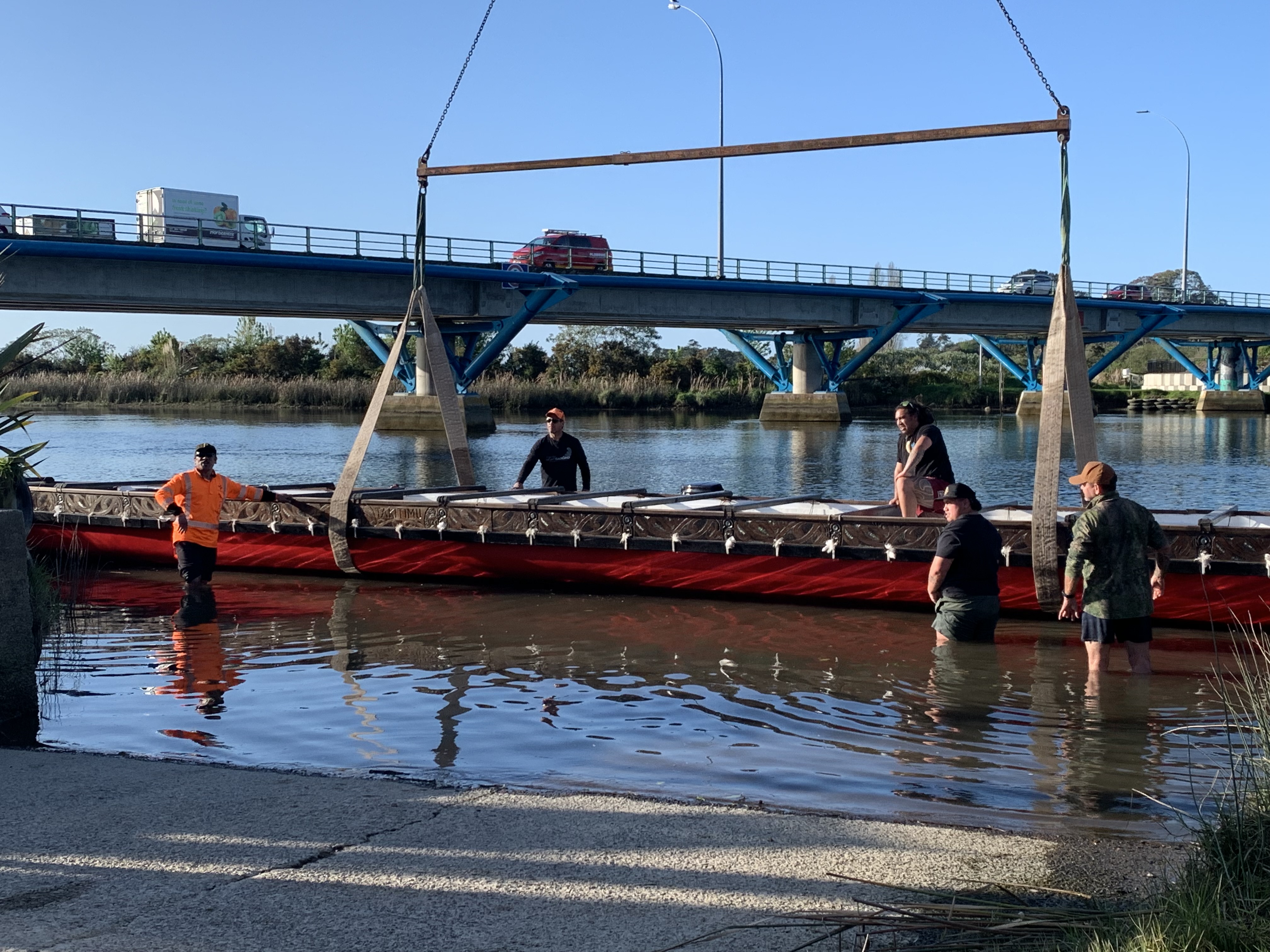 The 26.5m Takitimu waka being lifted by crane from the Wairoa River on Monday.