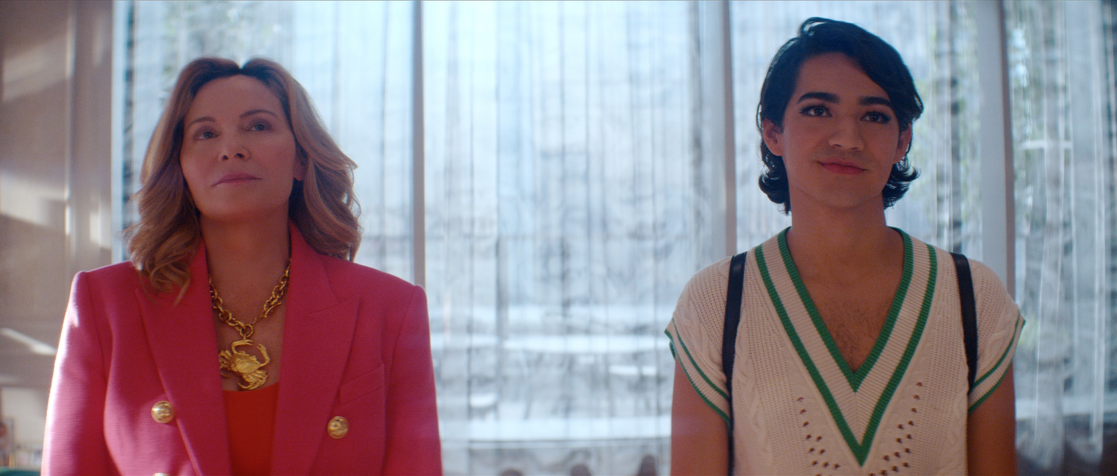 Office-wear, ‘Glamorous’-style. Kim Cattrall wears a Schiaparelli crab and Miss Benny (who plays Marco) wears a Sandro varsity sweater vest. Photo / Netflix