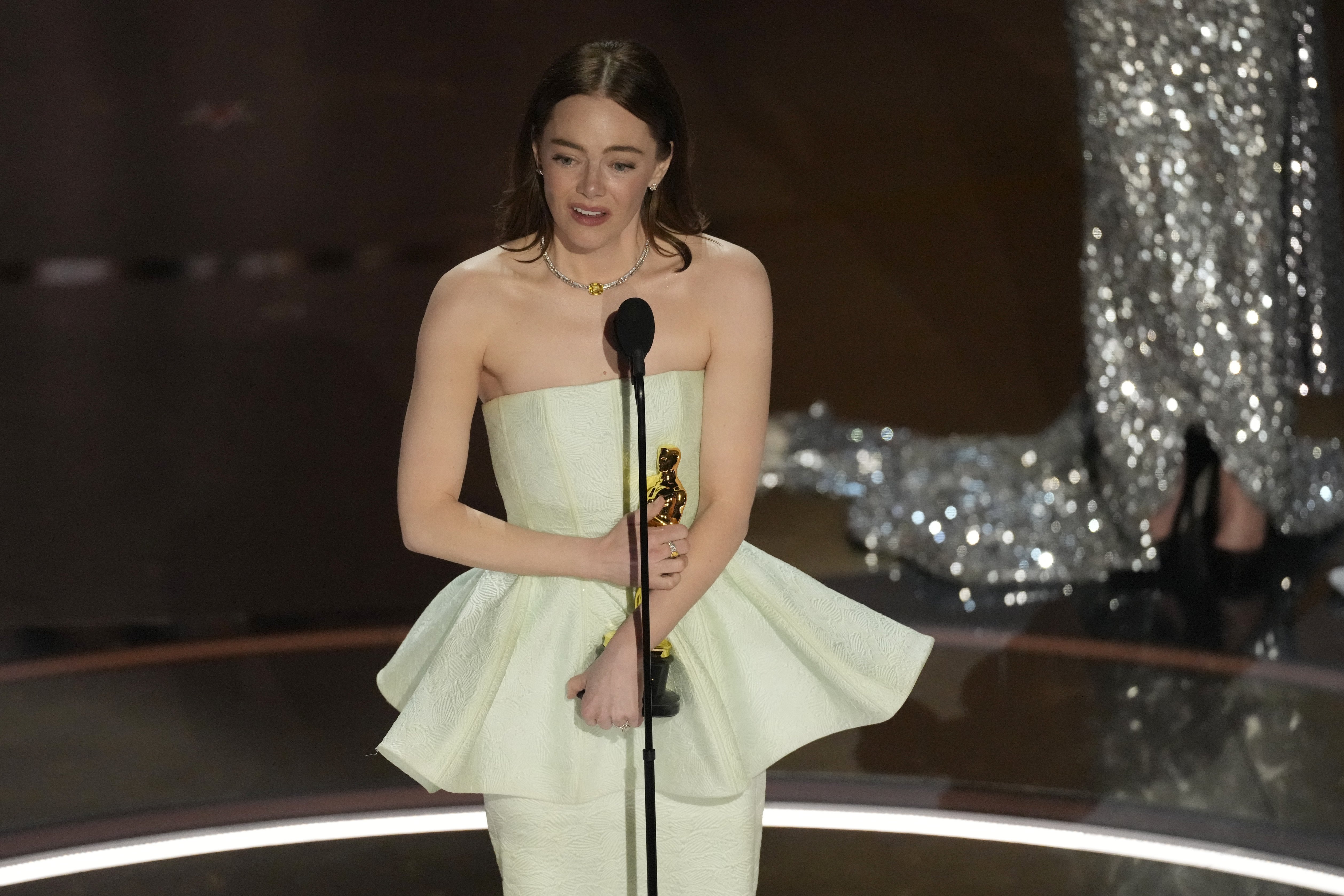 Emma Stone carried on with her acceptance speech despite her wardrobe malfunction. Photo / AP