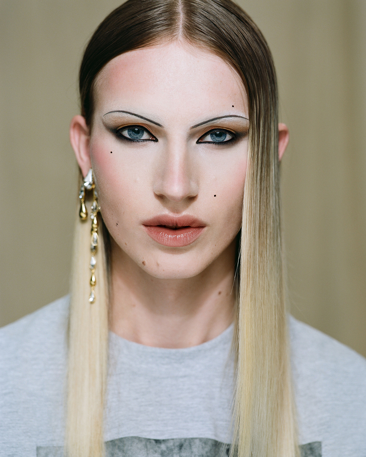 Milo wears Mitchell & Ness vintage tee $95. Ryan Storer earrings $650. Photo / Hone Naera-Scott