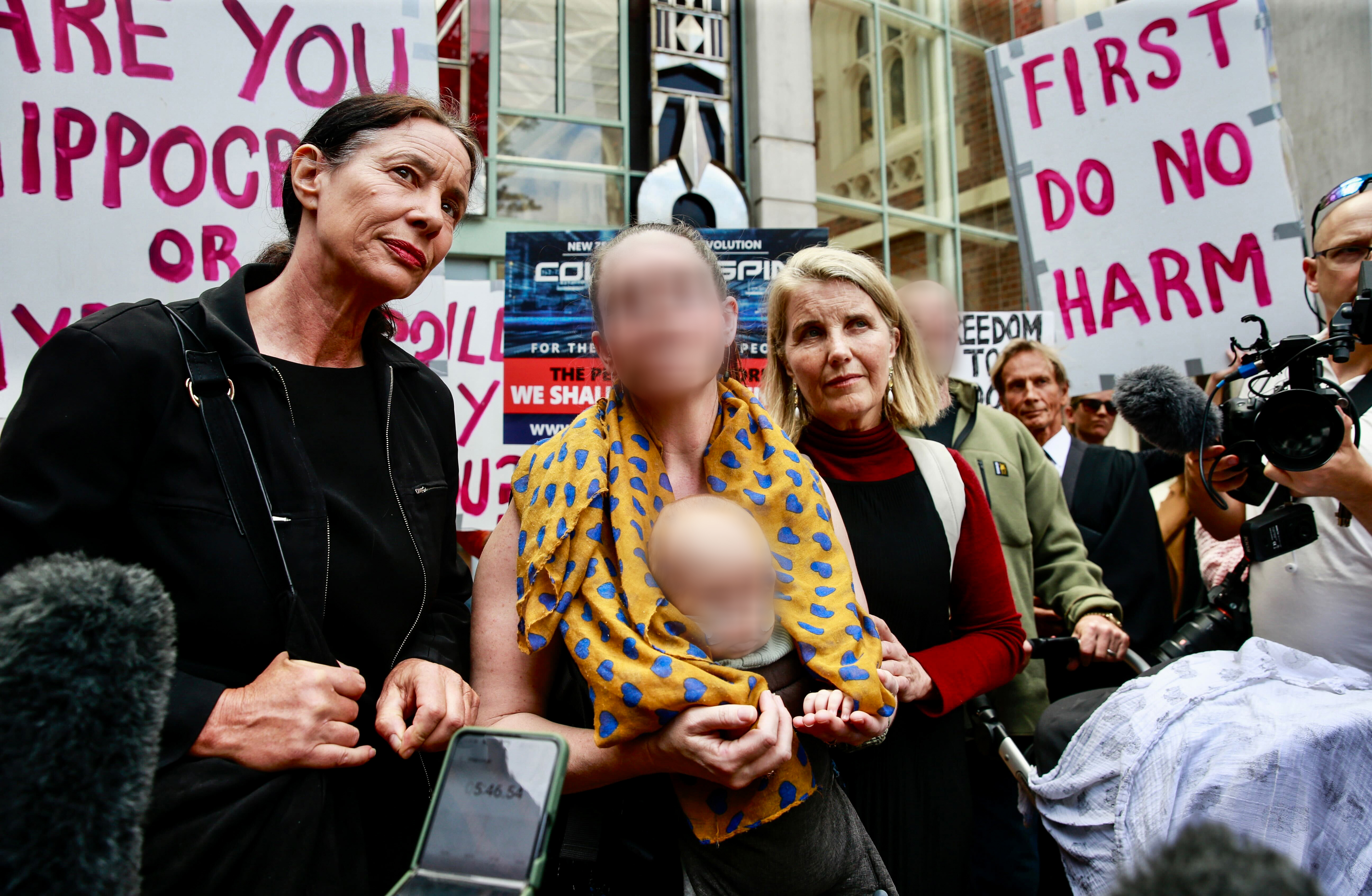 Anti-vaccination protestors, Lawyer Sue Grey along with Baby W's family and former newsreader-turned-conspiracist Liz Gunn outside the Auckland High Court. Photo / Alex Burton