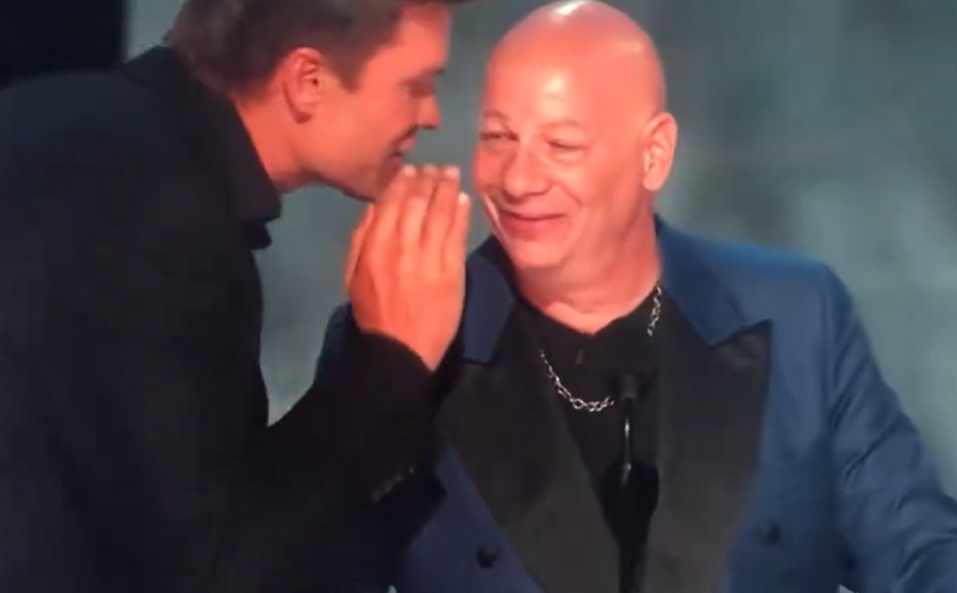 Former NFL star Tom Brady whispers in the ear of comedian Jeff Ross during the Netflix roast - The Roast of Tom Brady. Photo / via video