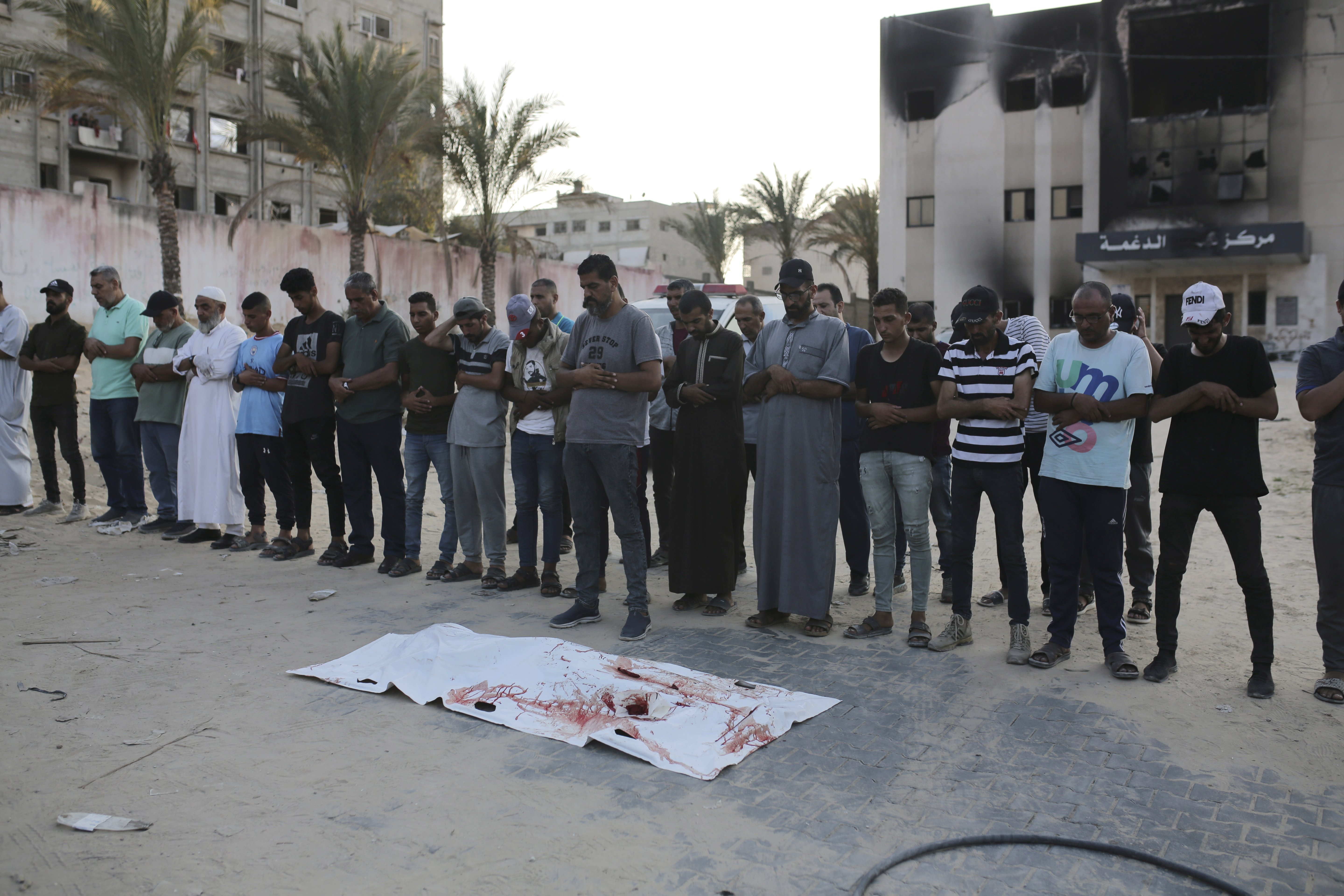 Palestinians pray for a victim of the conflict before their burial in Khan Younis. Photo / AP