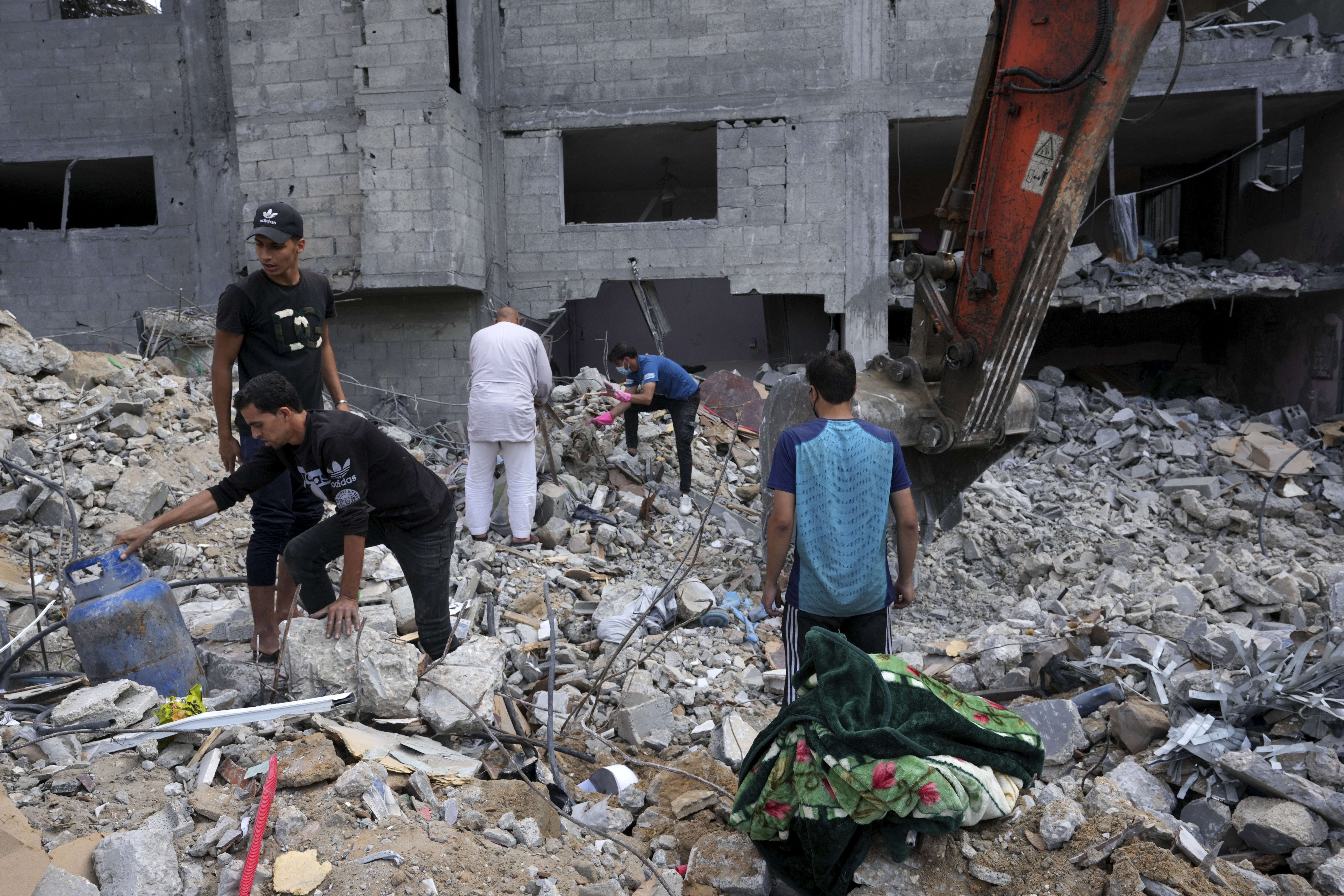 Palestinians recover the bodies of the al Meghari family killed in the Israeli bombardment of the Gaza Strip in Bureij refugee camp. Photo / AP