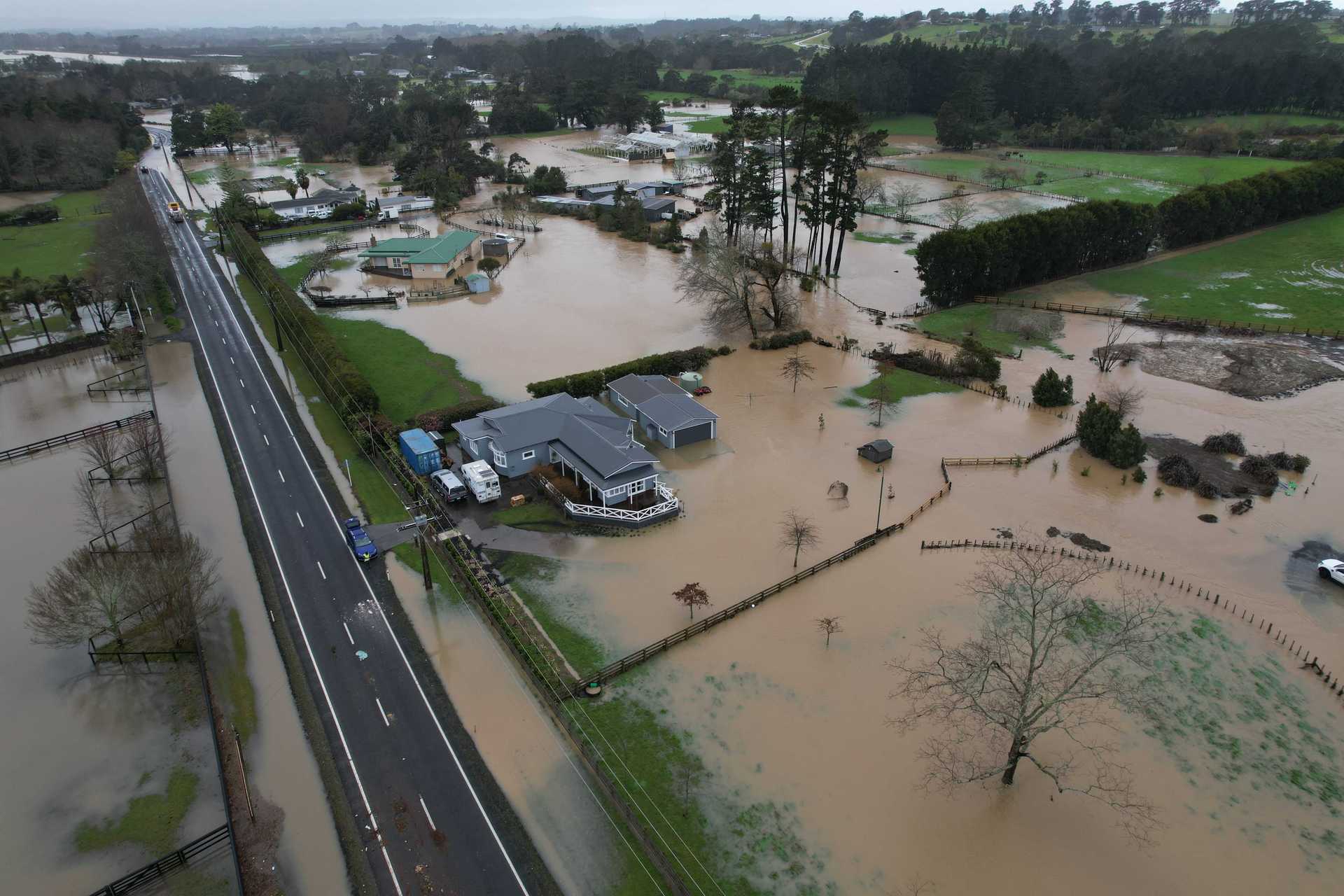 Flooding along Waitakere Road, Taupaki. Photo / Brett Phibbs