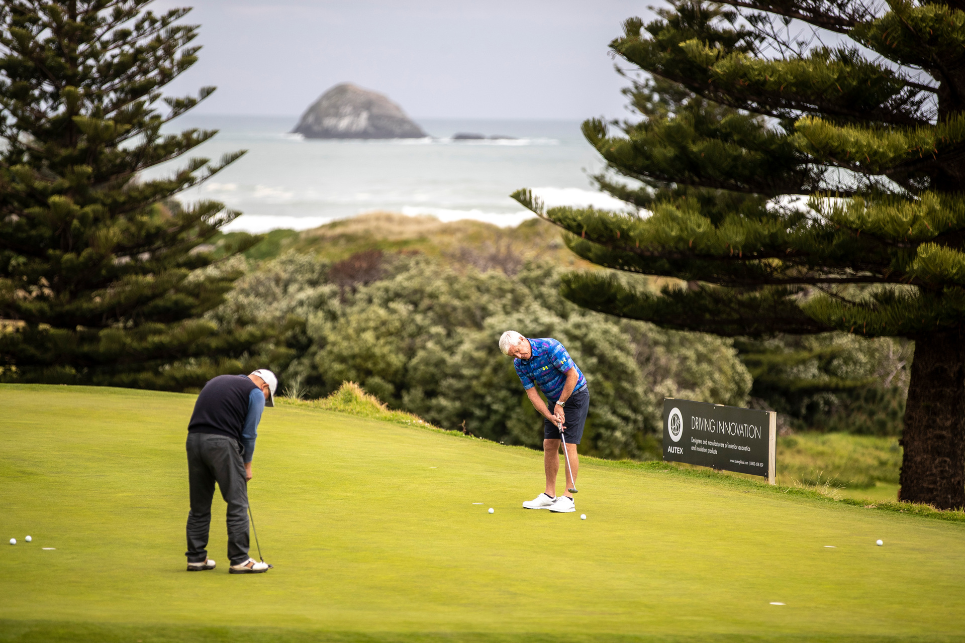 Players on the greens at the Muriwai Golf Club on the first day of courses being back open during Covid Level 3 restrictions. Photo / Michael Craig