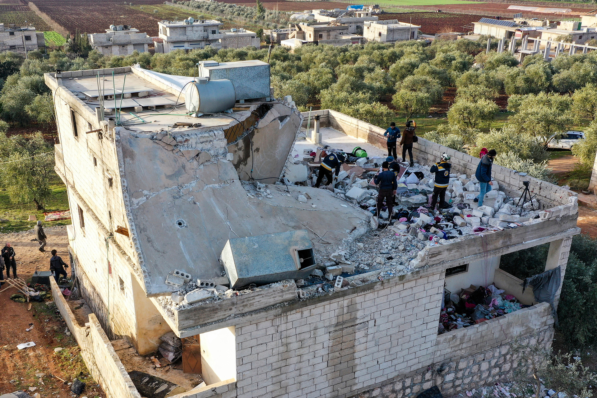 People inspect a destroyed house following an operation by the U.S. military in the Syrian village of Atmeh, in Idlib province, Syria.  Photo / AP