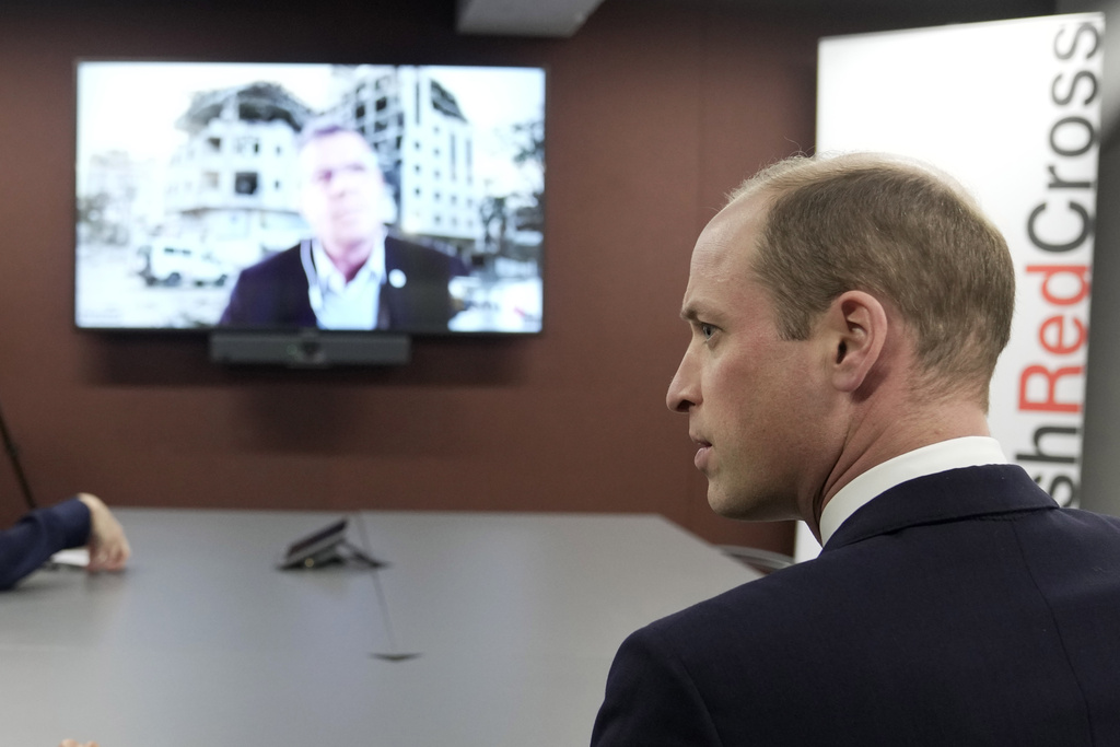 Britain's Prince William, The Prince of Wales, listens to Pascal Hundt, Senior Crisis Manager, International Committee of the Red Cross, dialling in from Gaza, during a visit of the British Red Cross at its headquarters in London, Tuesday, February 20. Photo / Kin Cheung, AP