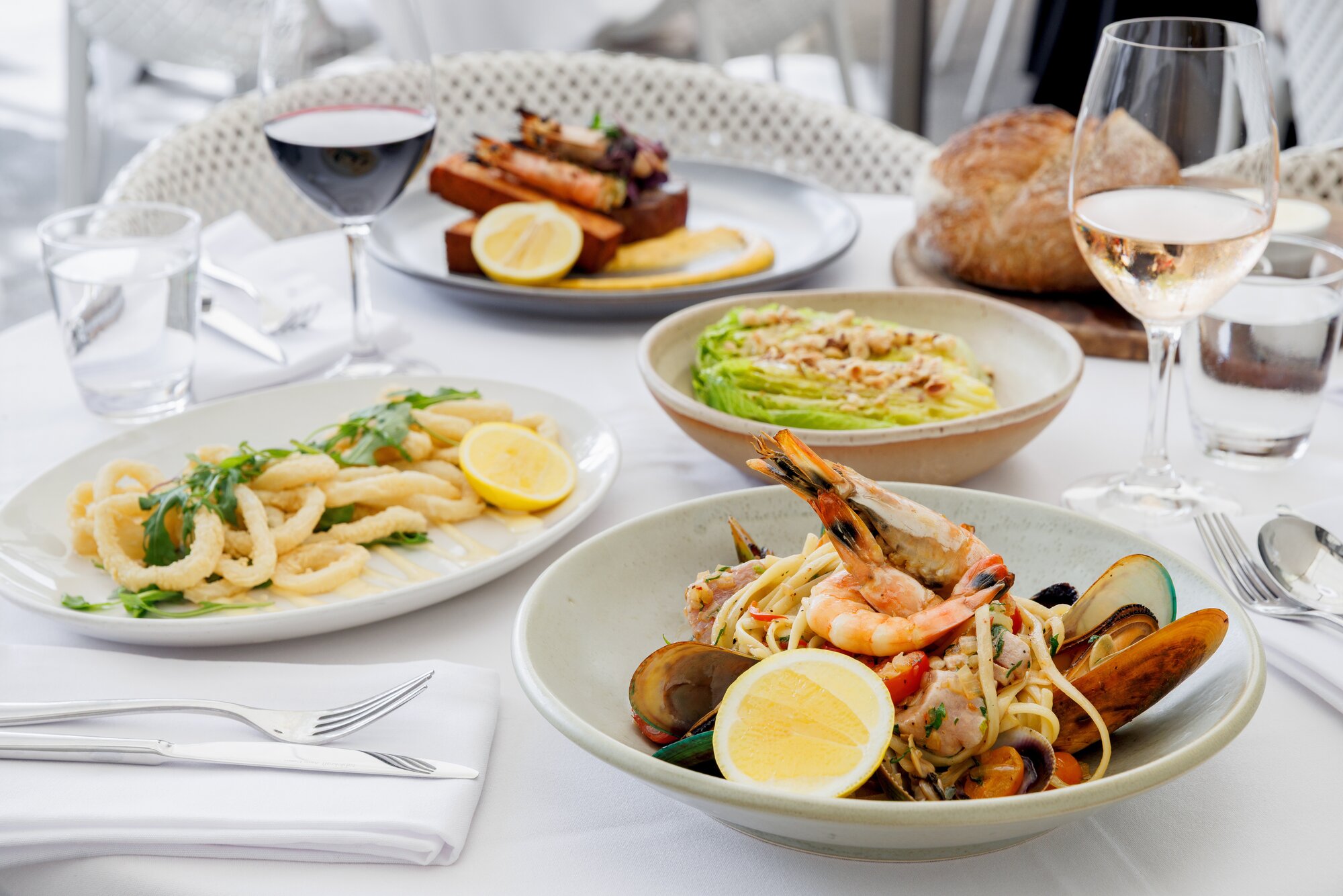 A selection of favourites on the menu at Prego: linguine alla marinara, calamari fritti, and surf and turf. Photo / Babiche Martens