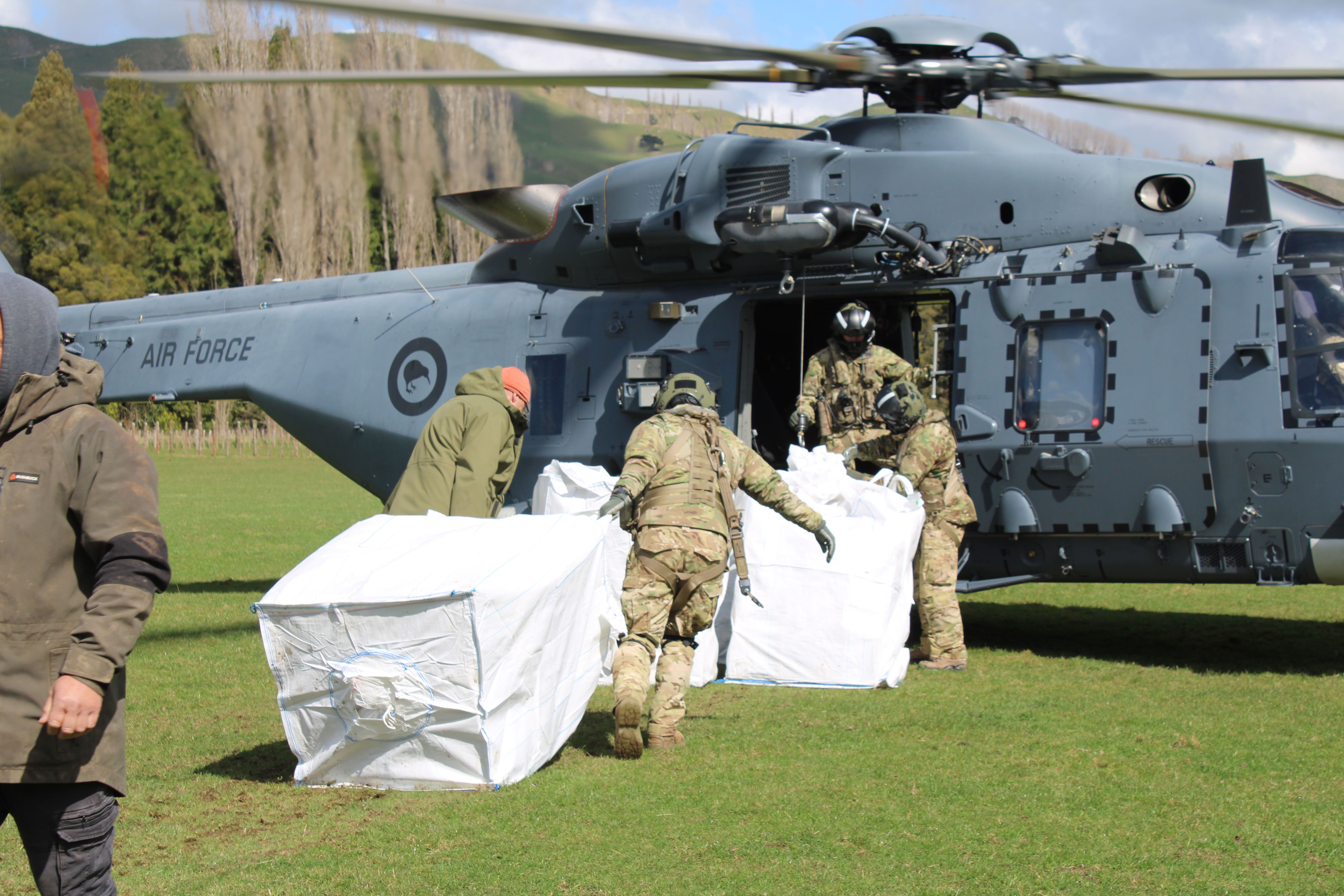 Te Papa Atawhai and Mauri Oho staff load bags of pest traps into an NH90 helicopter to be dropped into the Ruahine Range. Photo / CHB Mail
