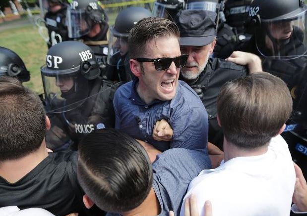 White nationalist Richard Spencer and his supporters clash with police in Lee Park after the 'Unite the Right' rally was declared an unlawful gathering in Charlottesville. Photo / Getty Images